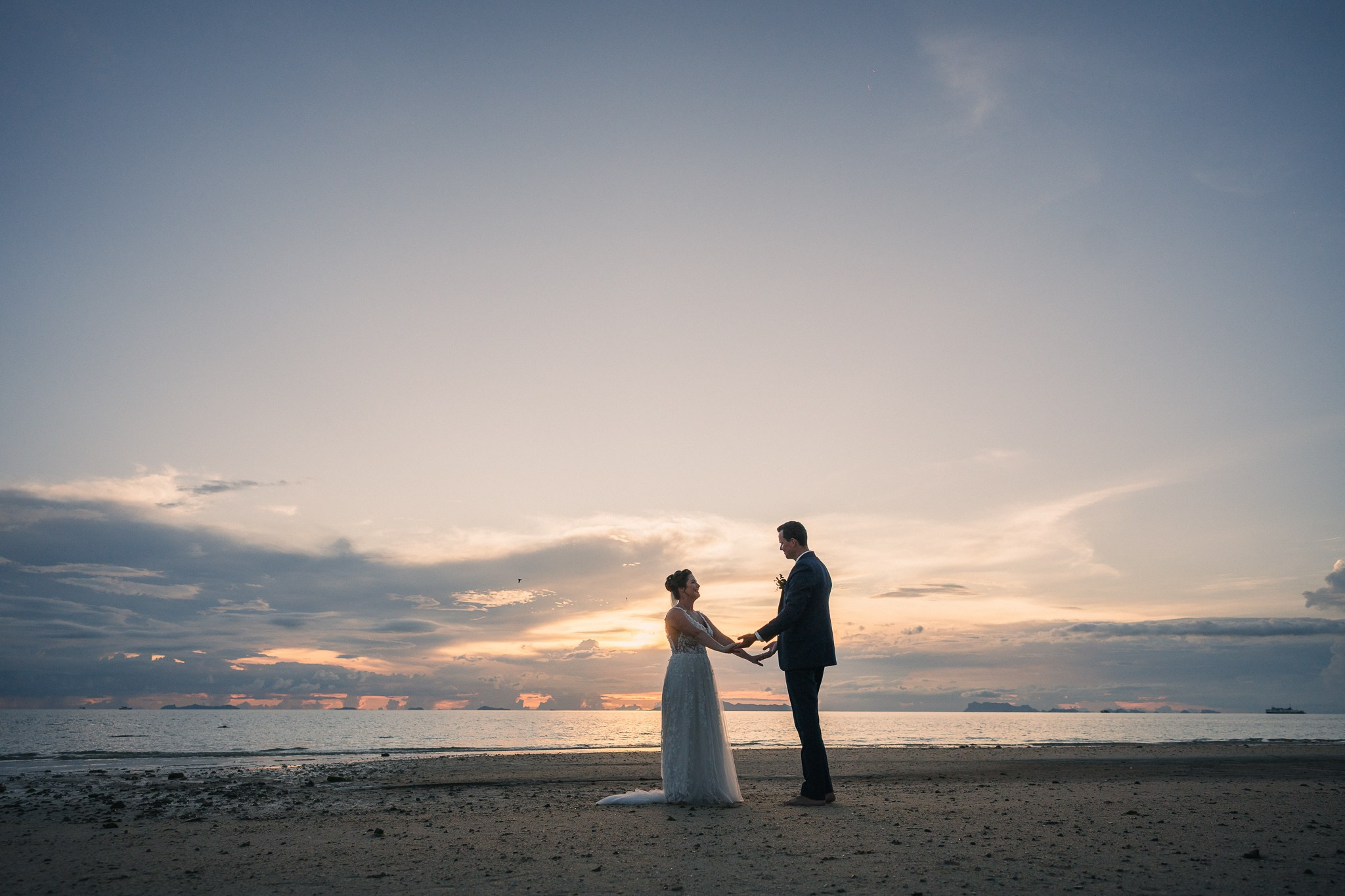 Destination beach wedding in Koh Samui, Thailand with the couple, family members and friends enjoying a tropical wedding ceremony by the sea