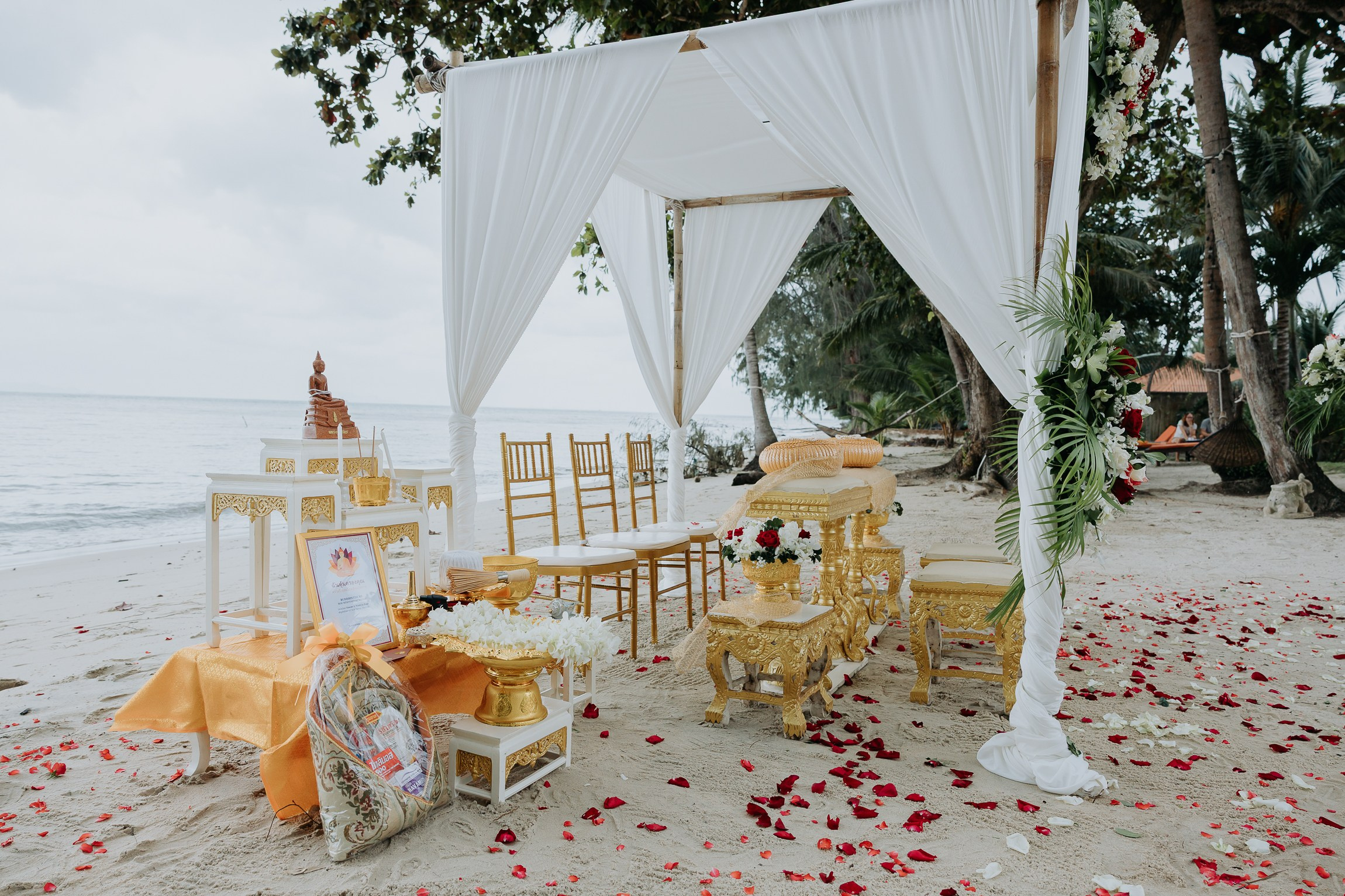Couple with guests celebrating a spiritual Buddhist wedding ceremony on Koh Samui