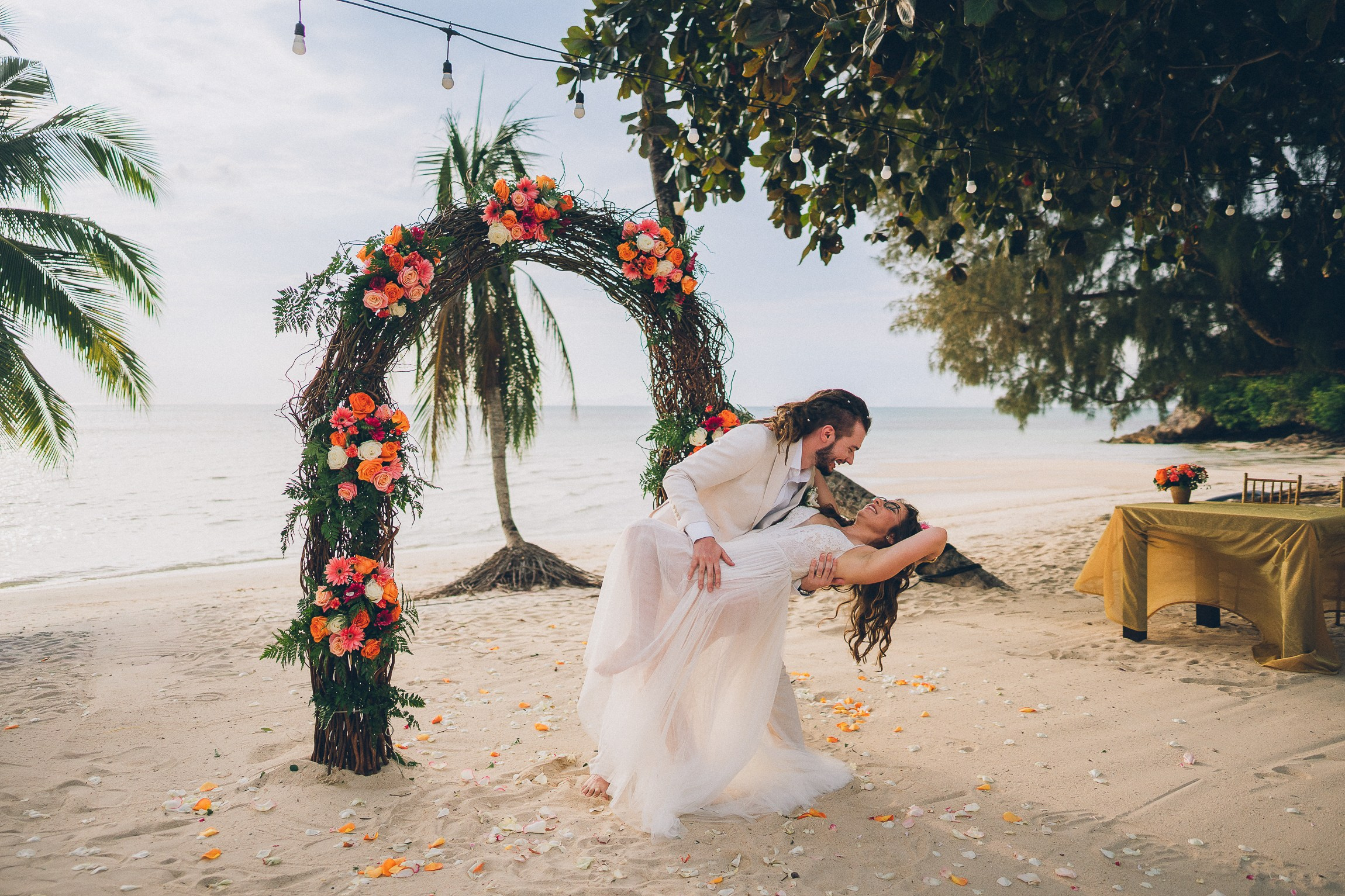 Intimate wedding for two on a tropical beach in Koh Samui, Thailand with a floral wedding setup and sea view