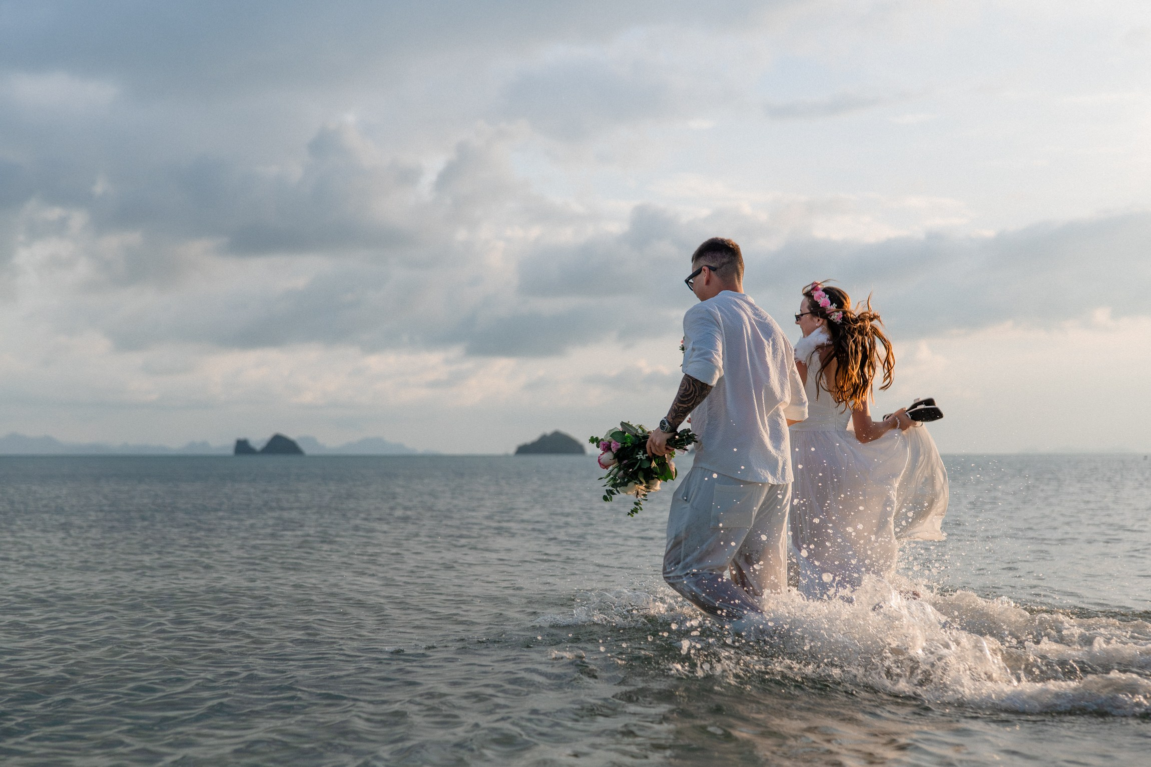 Bride and groom exchanging vows on a private sunset beach