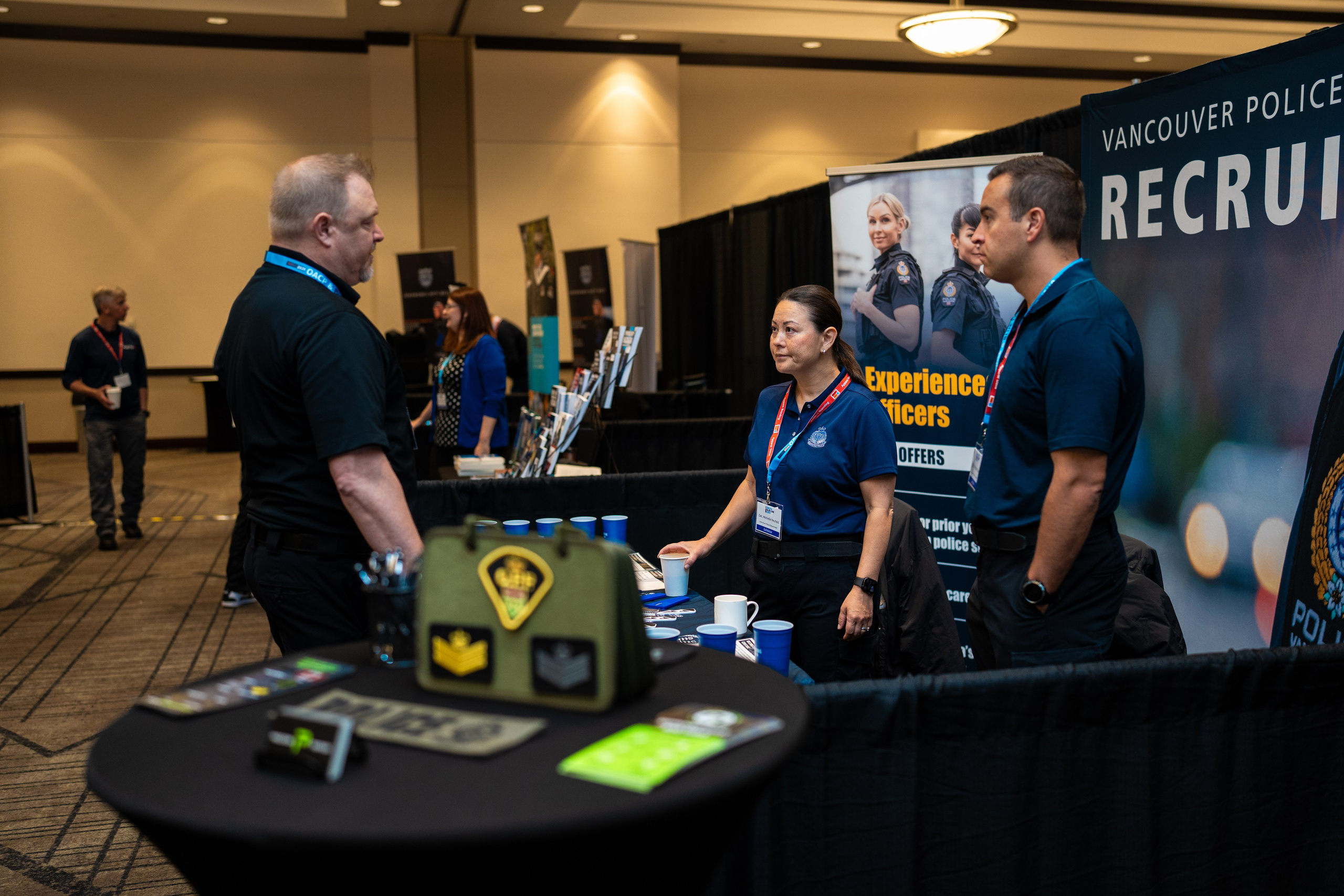 Attendee and exhibitor at booth table, Blueline Expo 2026