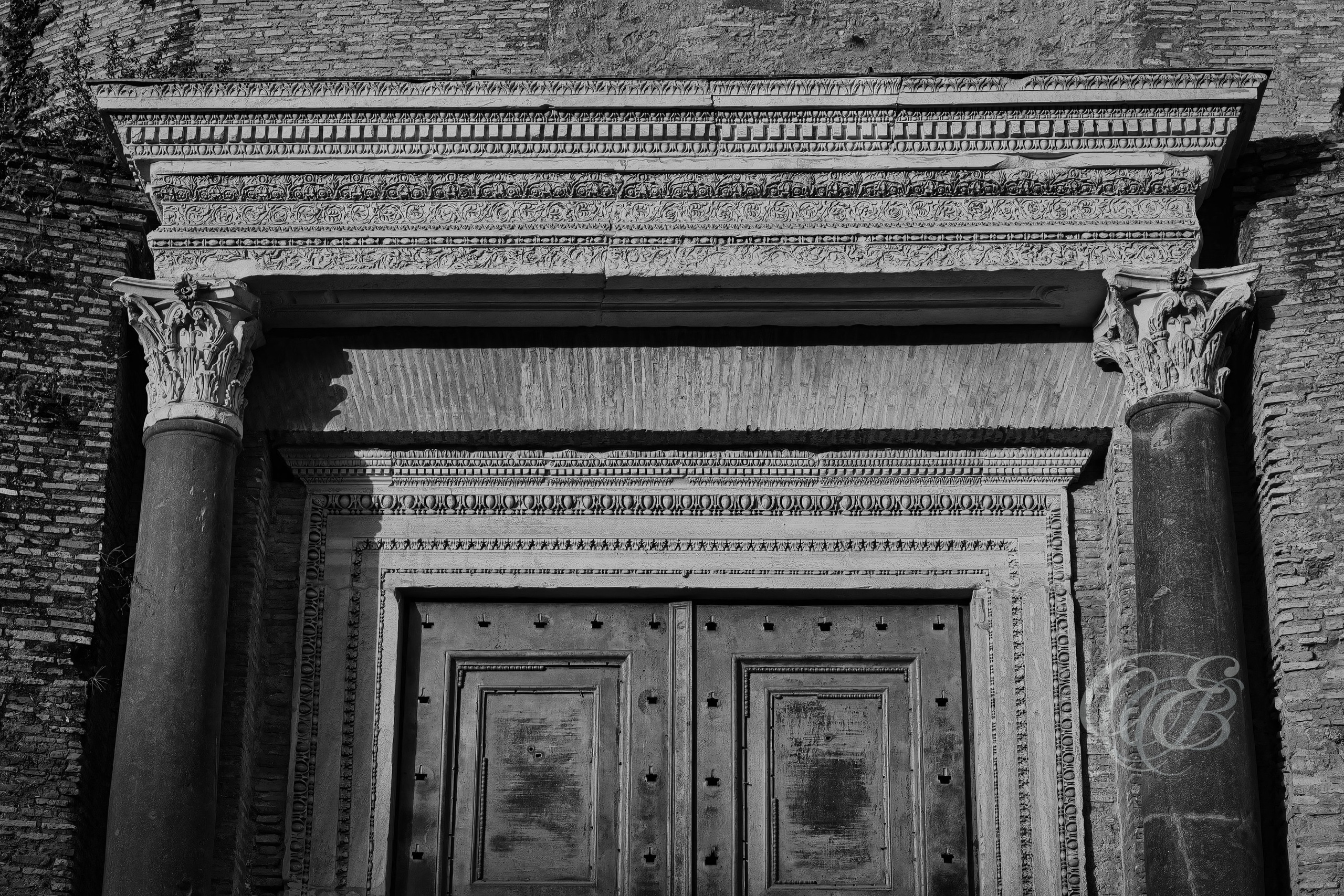 Rome Italy – Temple of Romulus in the Roman Forum, circular ancient Roman structure with bronze doors, captured in black and white fine art photography. Rome, Italy – photography by Eduardo Bartoli.