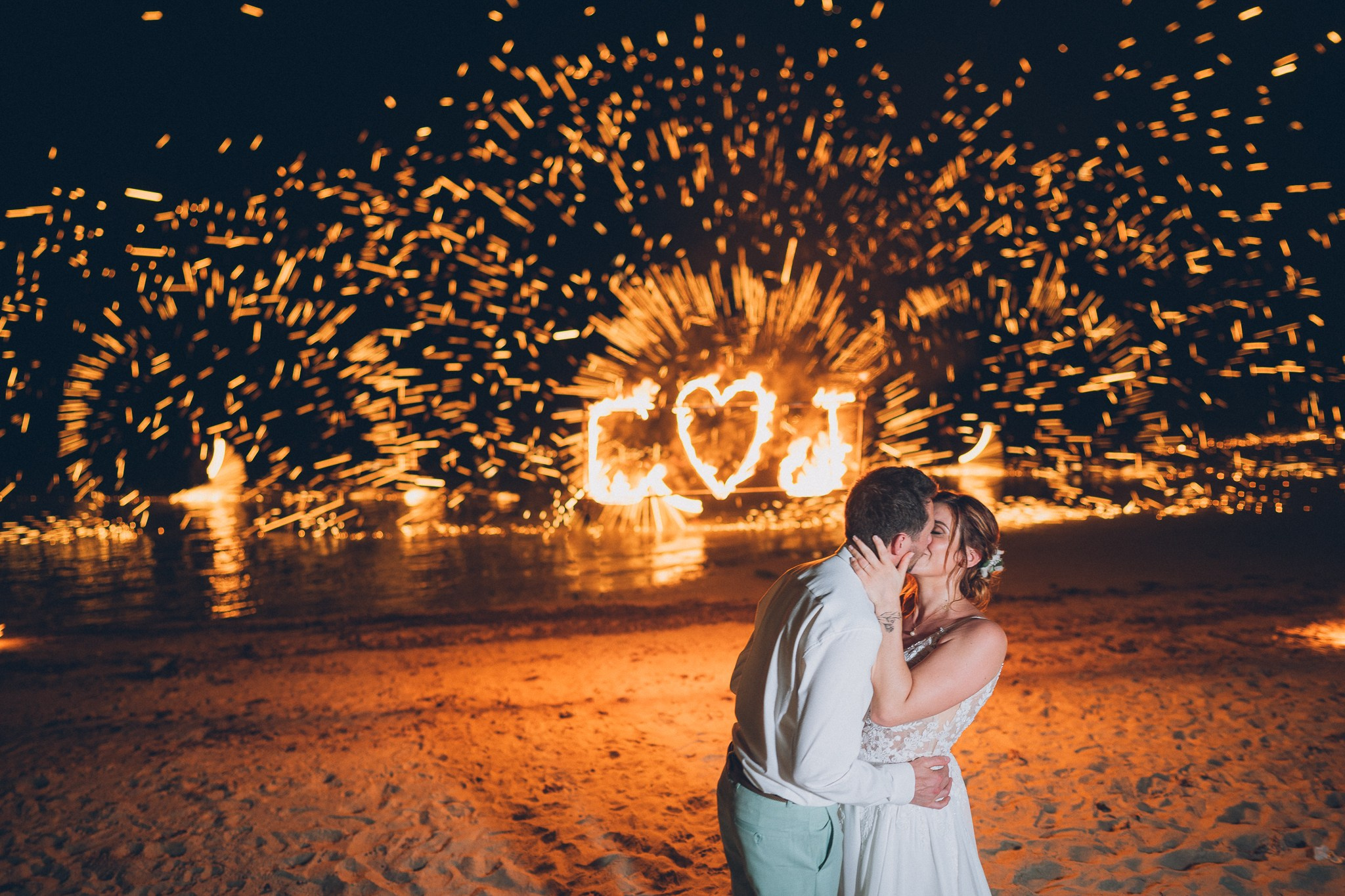 Spectacular fire show performance during a beach wedding reception in Koh Samui