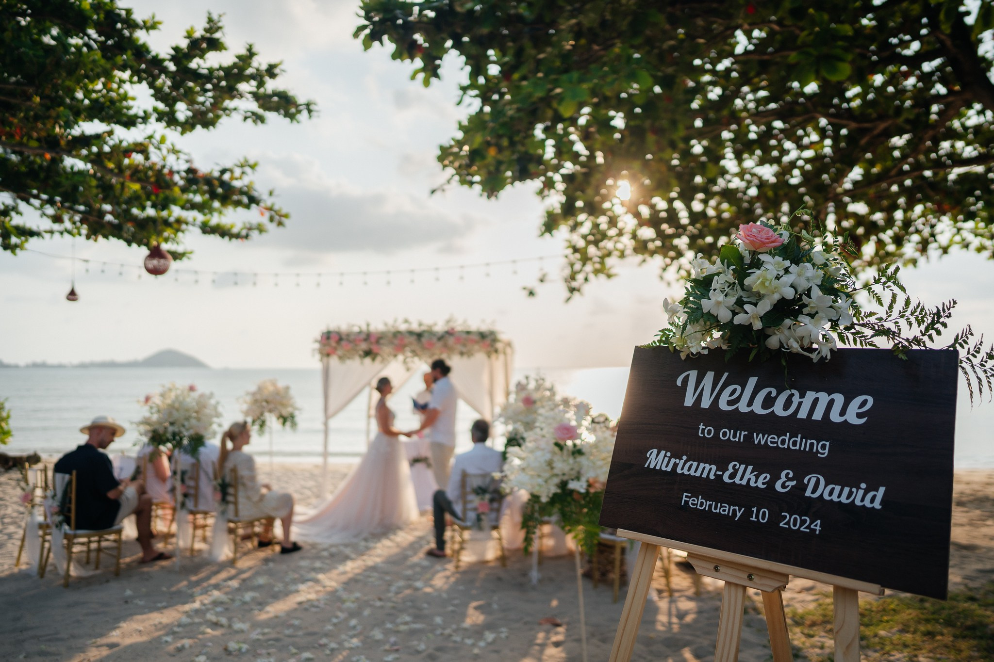 Destination beach wedding in Koh Samui, Thailand with the couple, family members and friends enjoying a tropical wedding ceremony by the sea