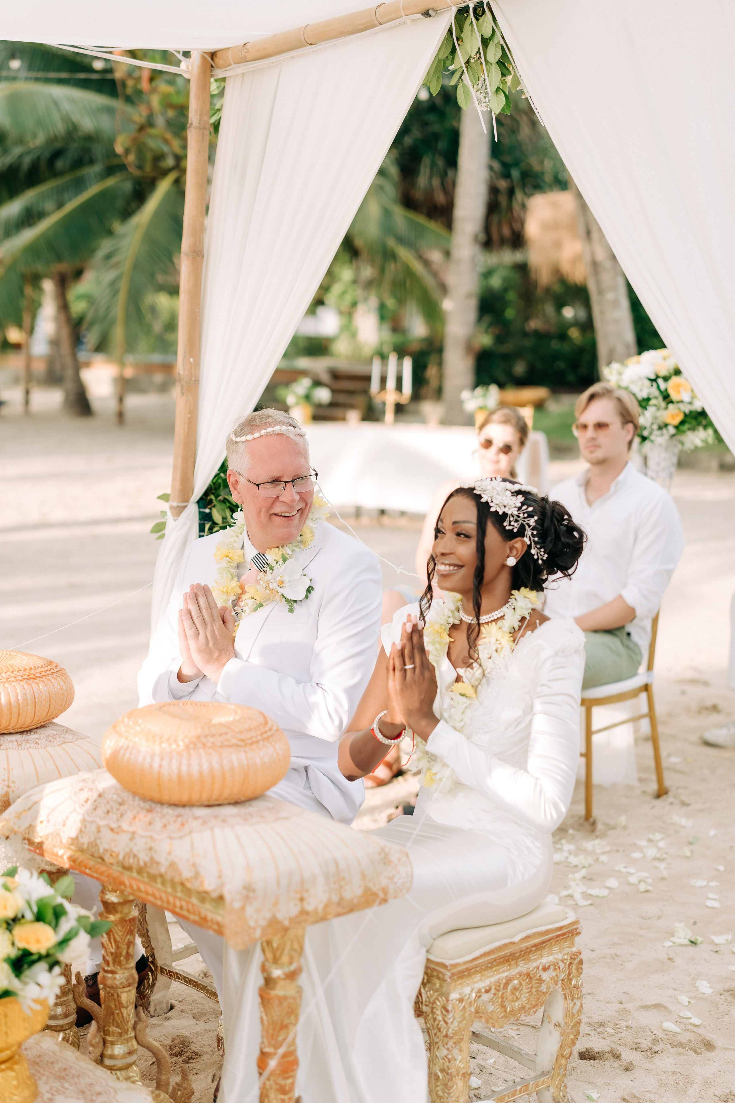 Couple receiving a traditional Buddhist wedding blessing from Thai monks in Koh Samui