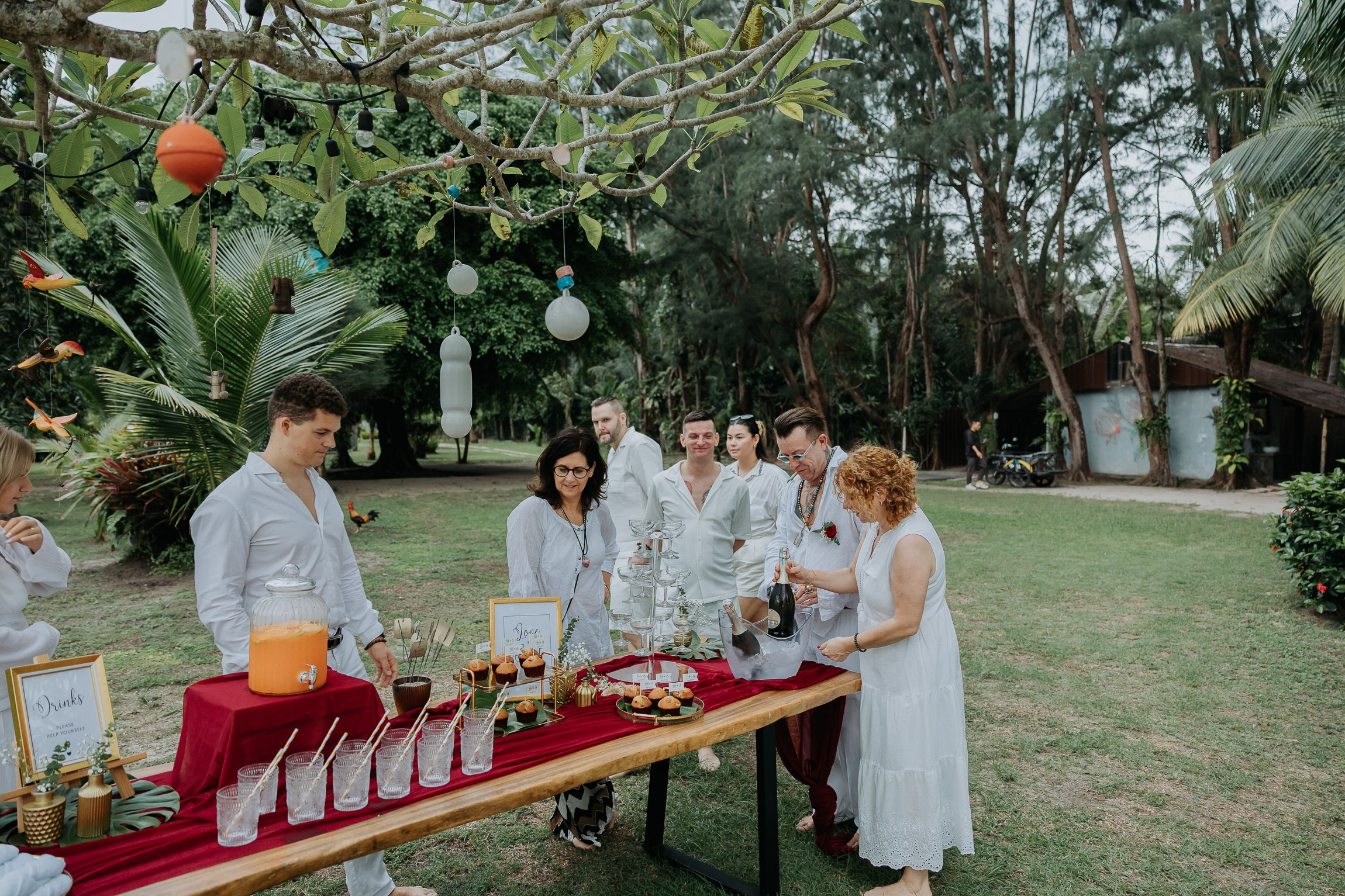Bride and groom participating in a sacred Buddhist wedding blessing in Thailand