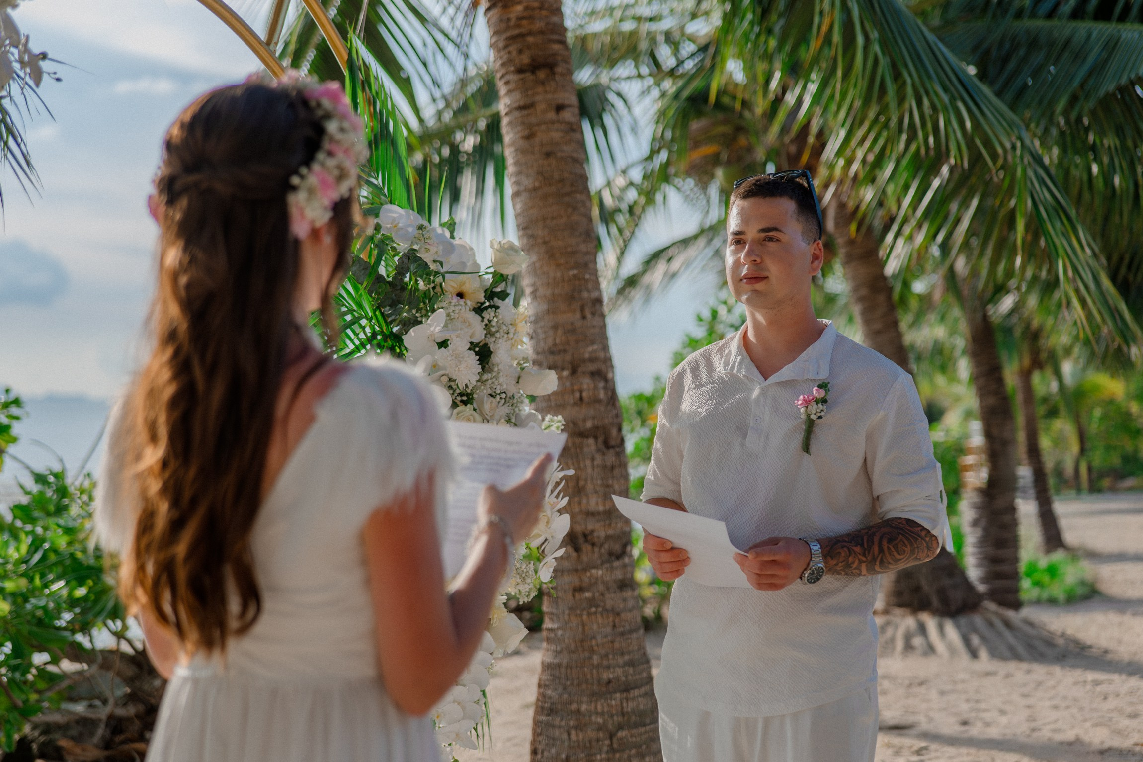 Bride and groom during a romantic beach wedding ceremony on Koh Samui, Thailand, surrounded by tropical scenery and ocean views