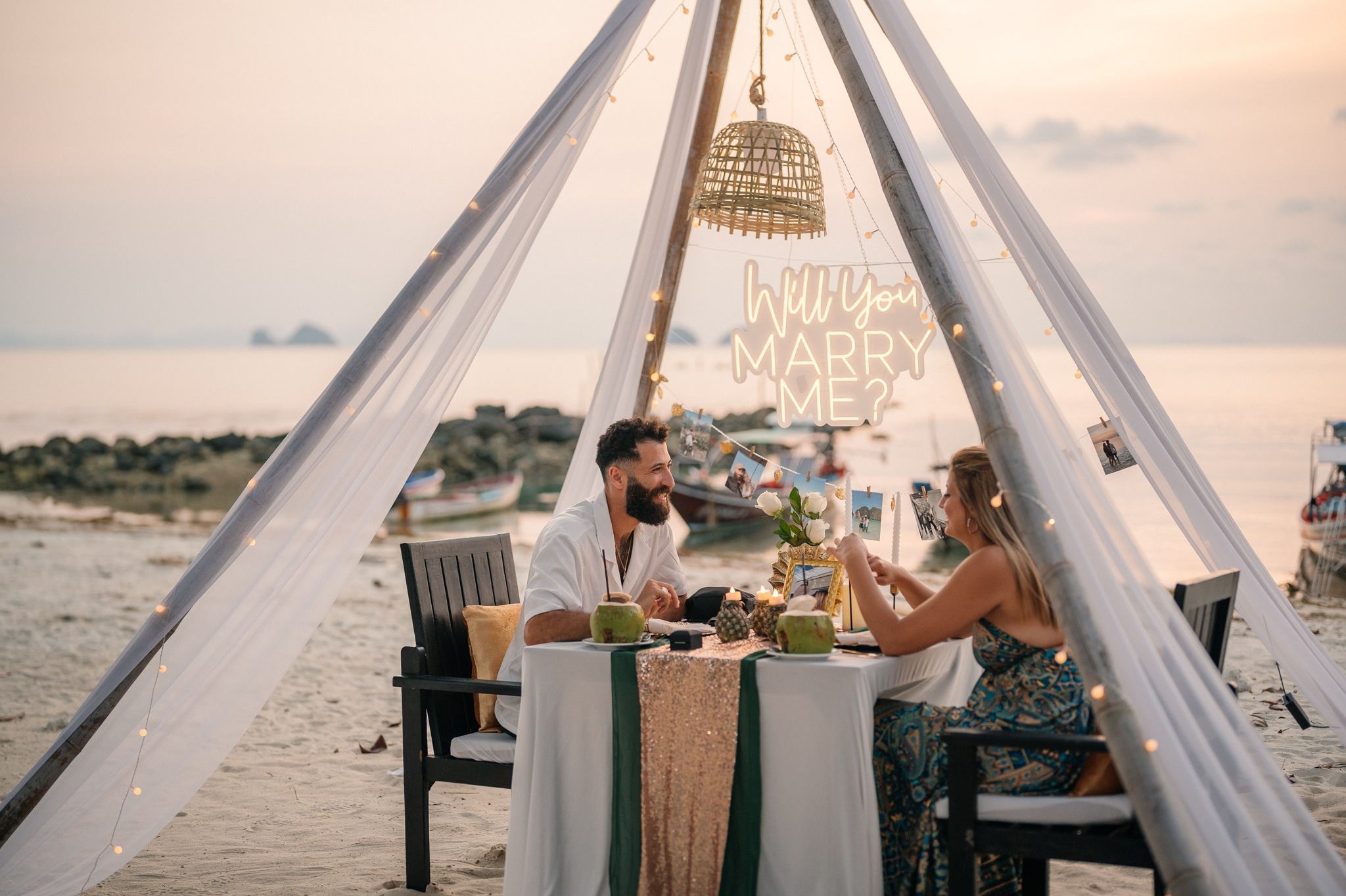 Elegant “Marry Me” beach proposal setup in Koh Samui with rose petals and tropical decor.