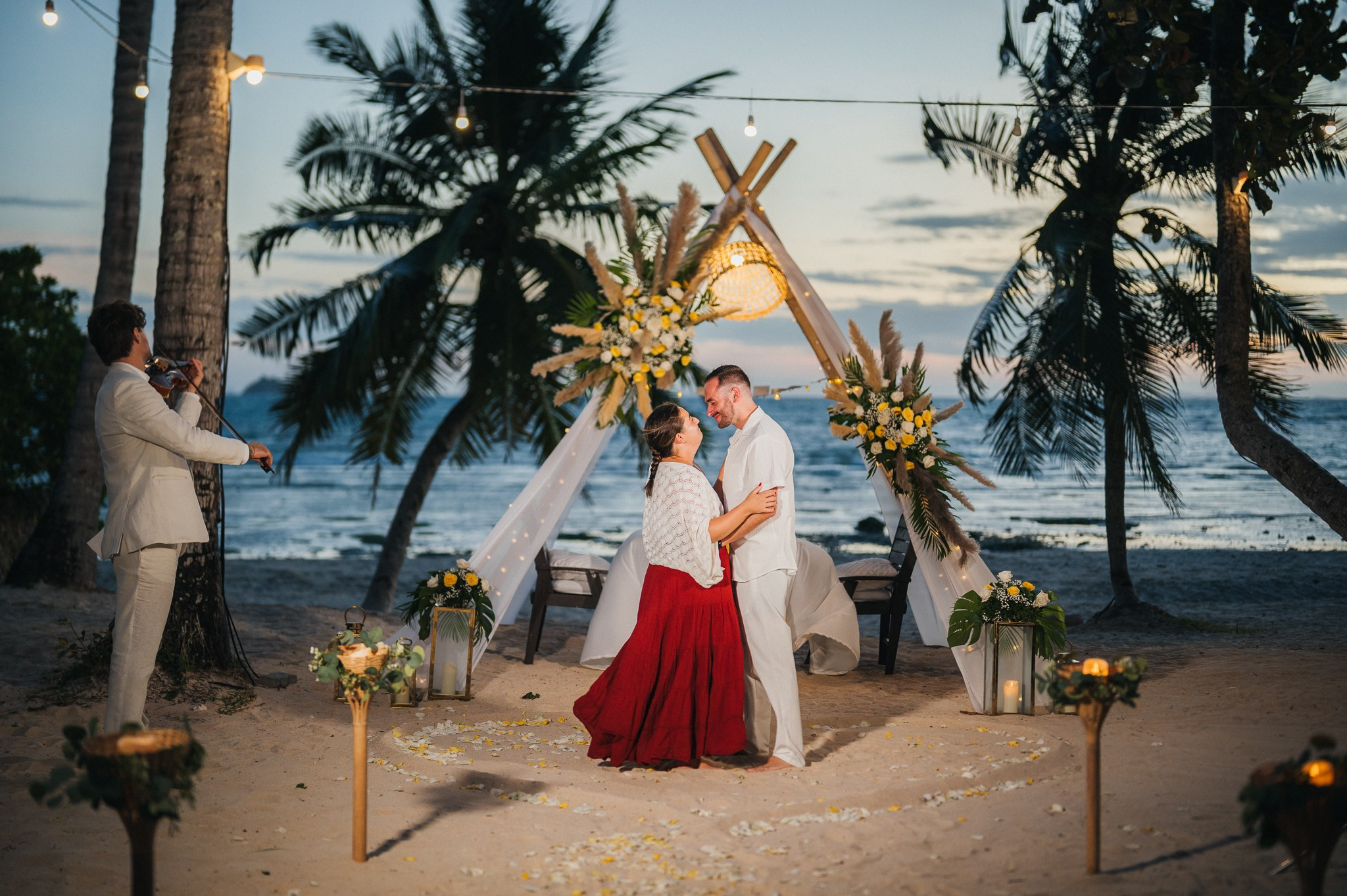Elegant “Marry Me” beach proposal setup in Koh Samui with rose petals and tropical decor.