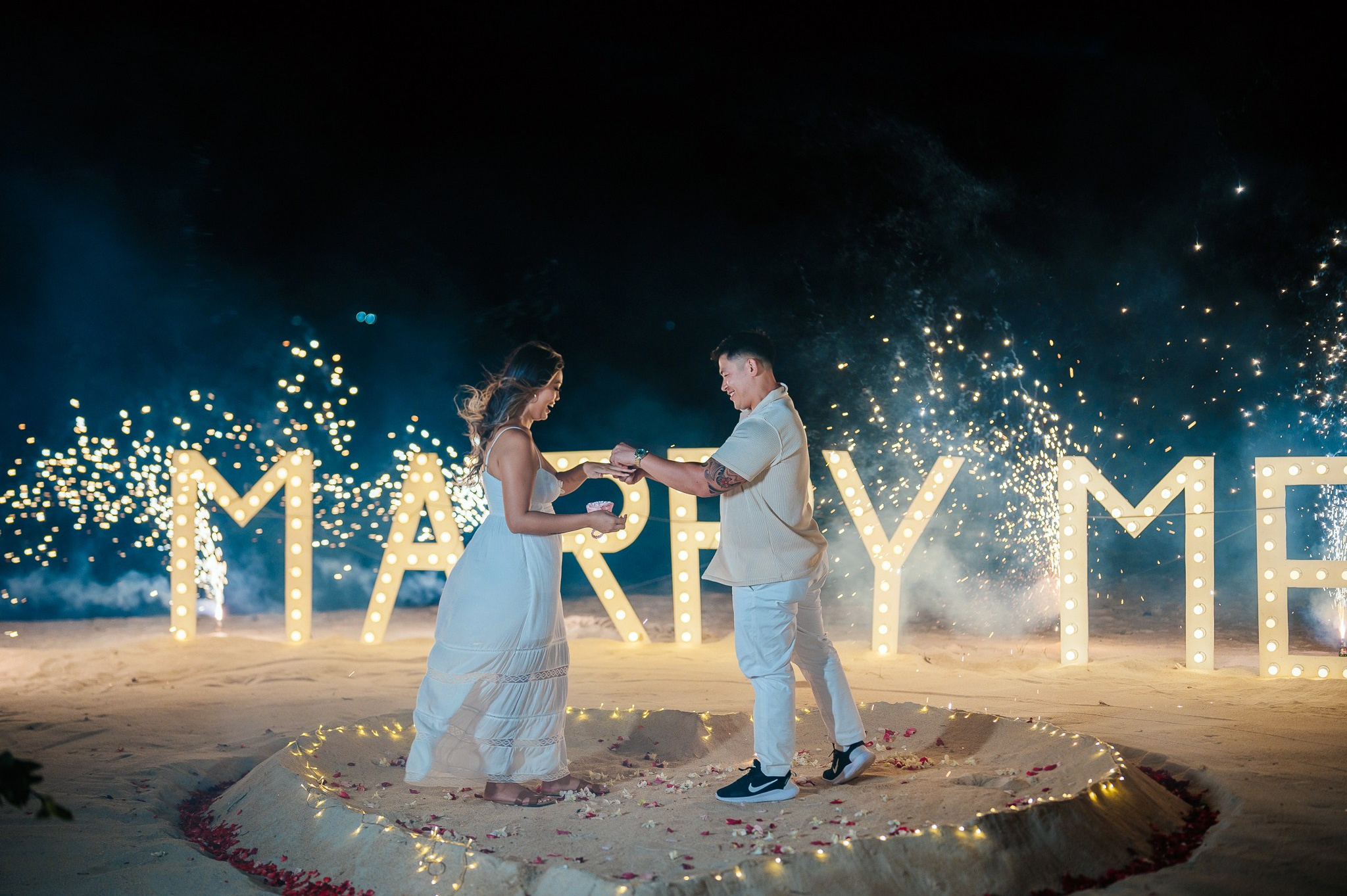 Luxury marriage proposal on a private beach in Koh Samui with flower decorations and romantic lighting.