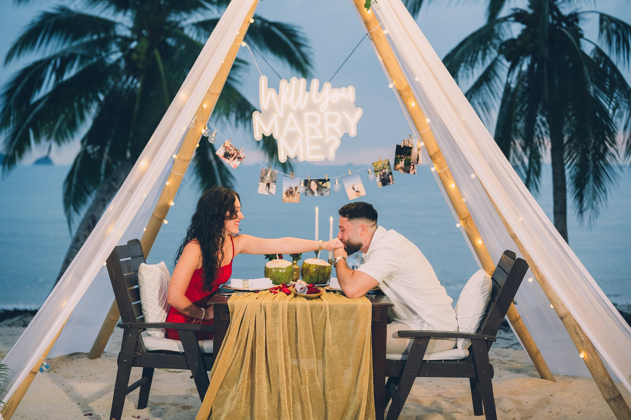 Romantic dinner for two under a decorated beach teepee in Pattaya after a marriage proposal.