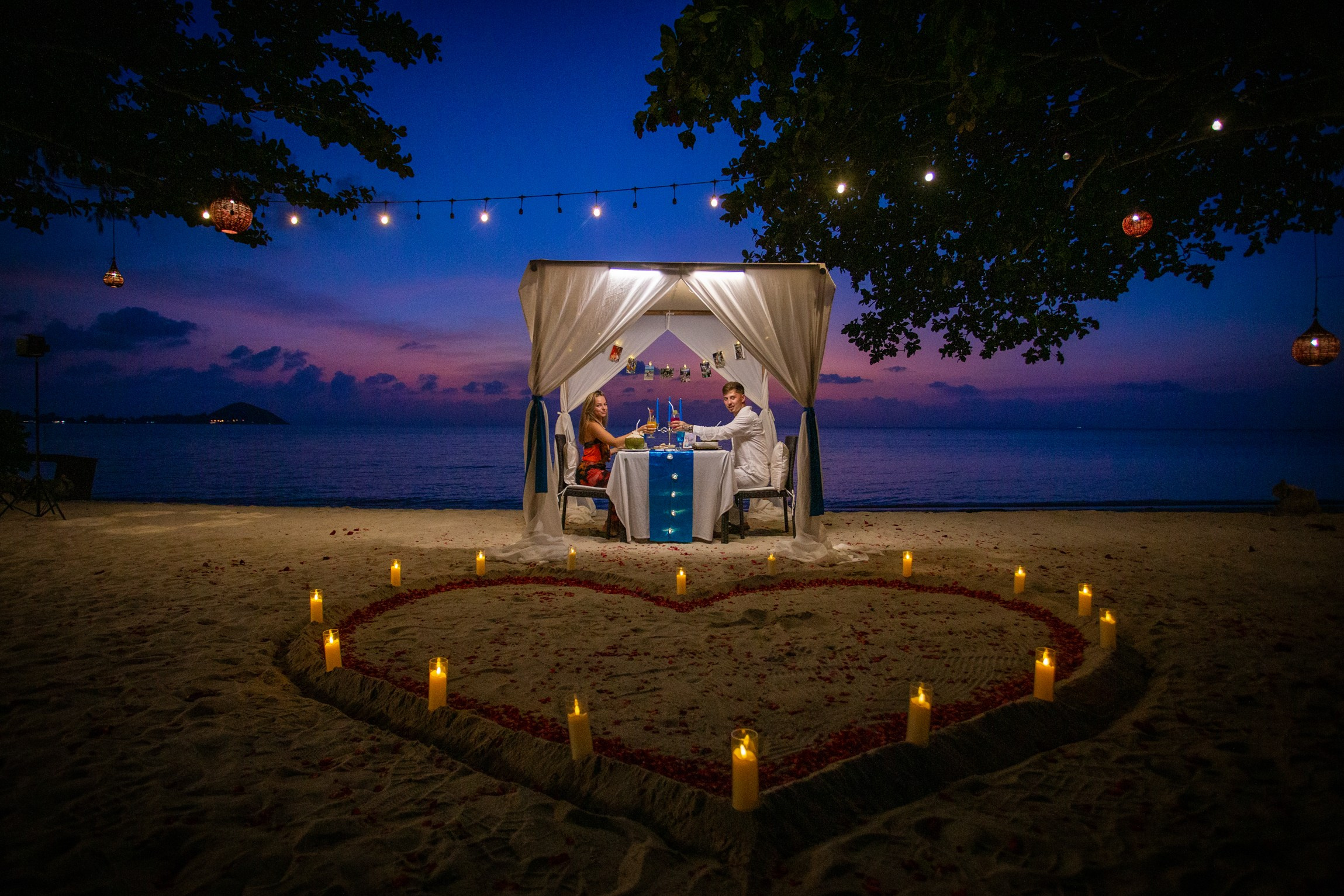 Luxury marriage proposal on a private beach in Koh Samui with flower decorations and romantic lighting.