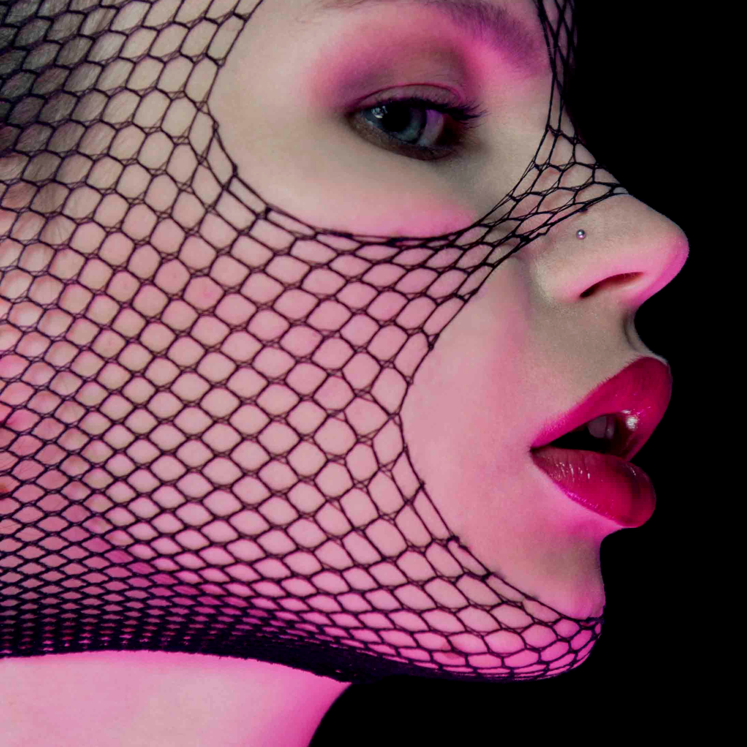 Creative portrait of woman with fishnet veil and pink makeup - artistic photographer Mexico City