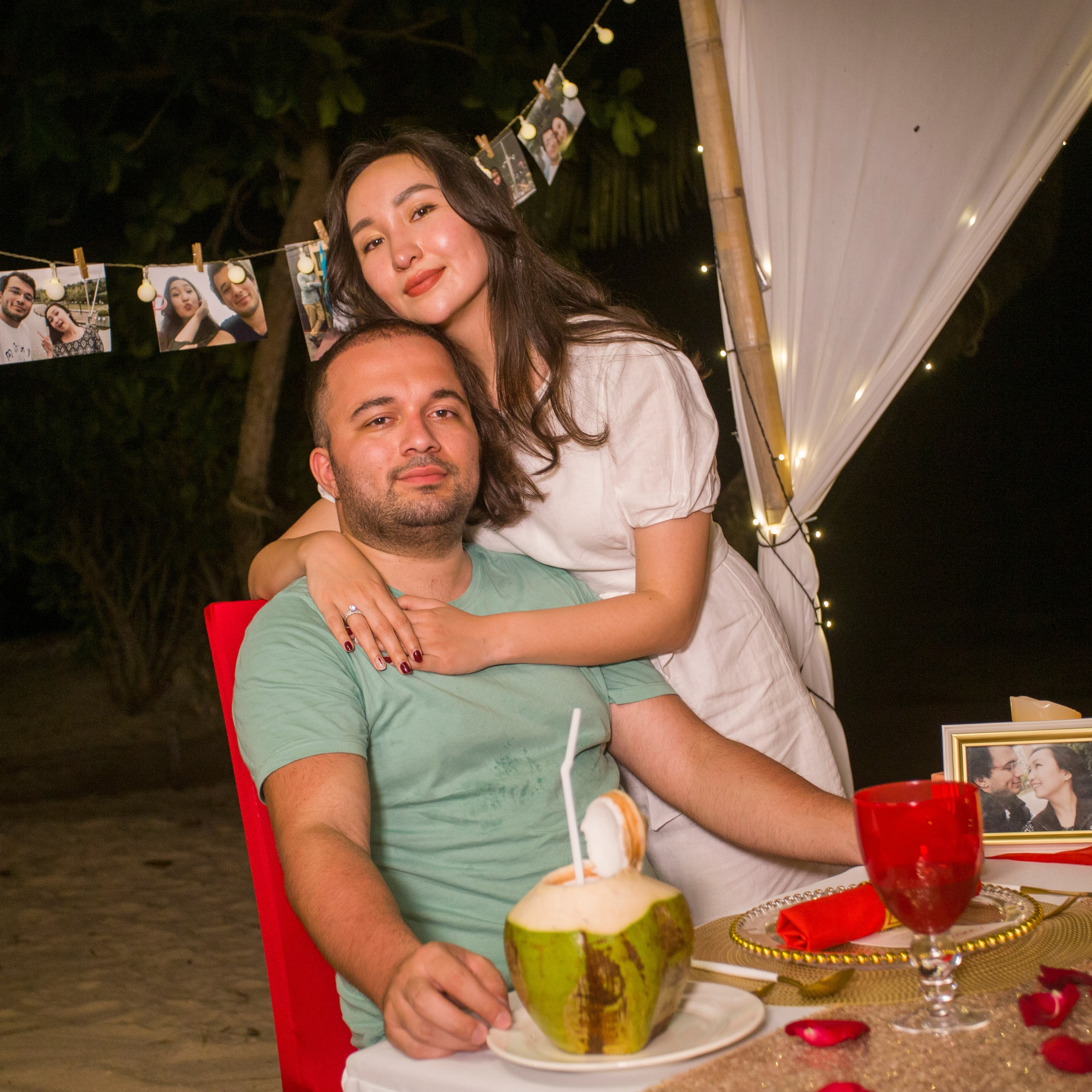 Romantic beach proposal setup in Koh Samui with candles and flower arch.