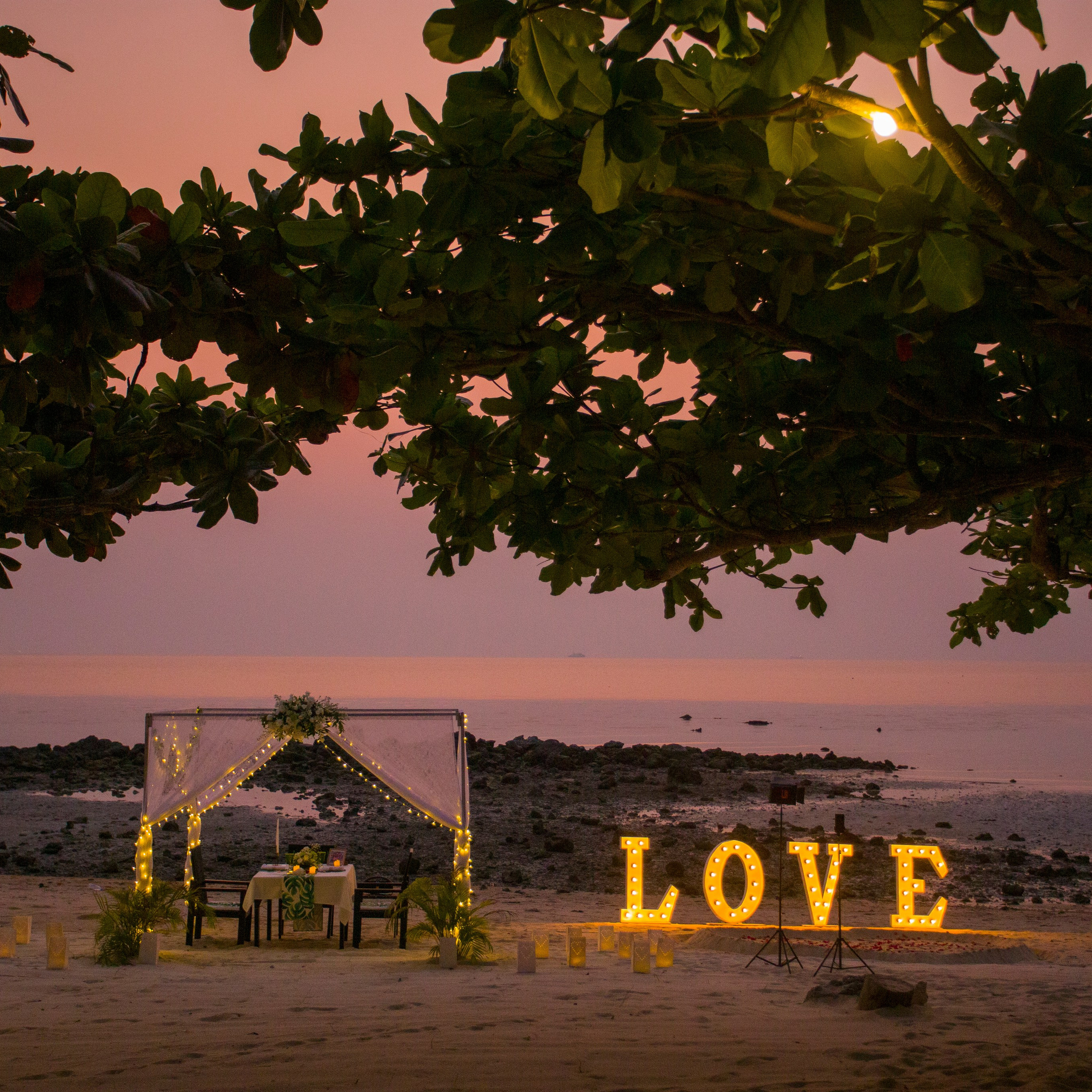 Luxury beach proposal in Koh Samui, Thailand. Private sunset setup with candles, flowers, and ocean view for an unforgettable engagement experience.