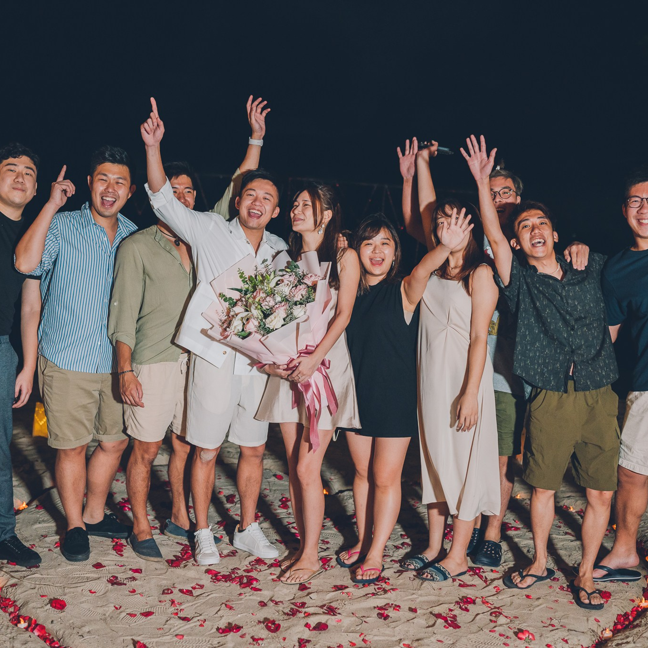 Romantic beach proposal setup in Koh Samui with candles and flower arch.