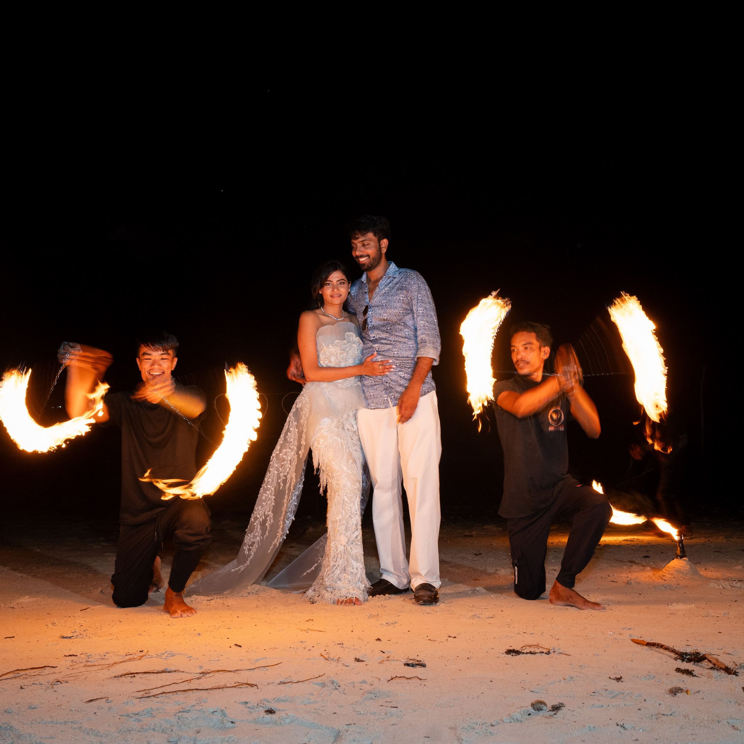 Romantic beach proposal setup in Koh Samui with candles and flower arch.