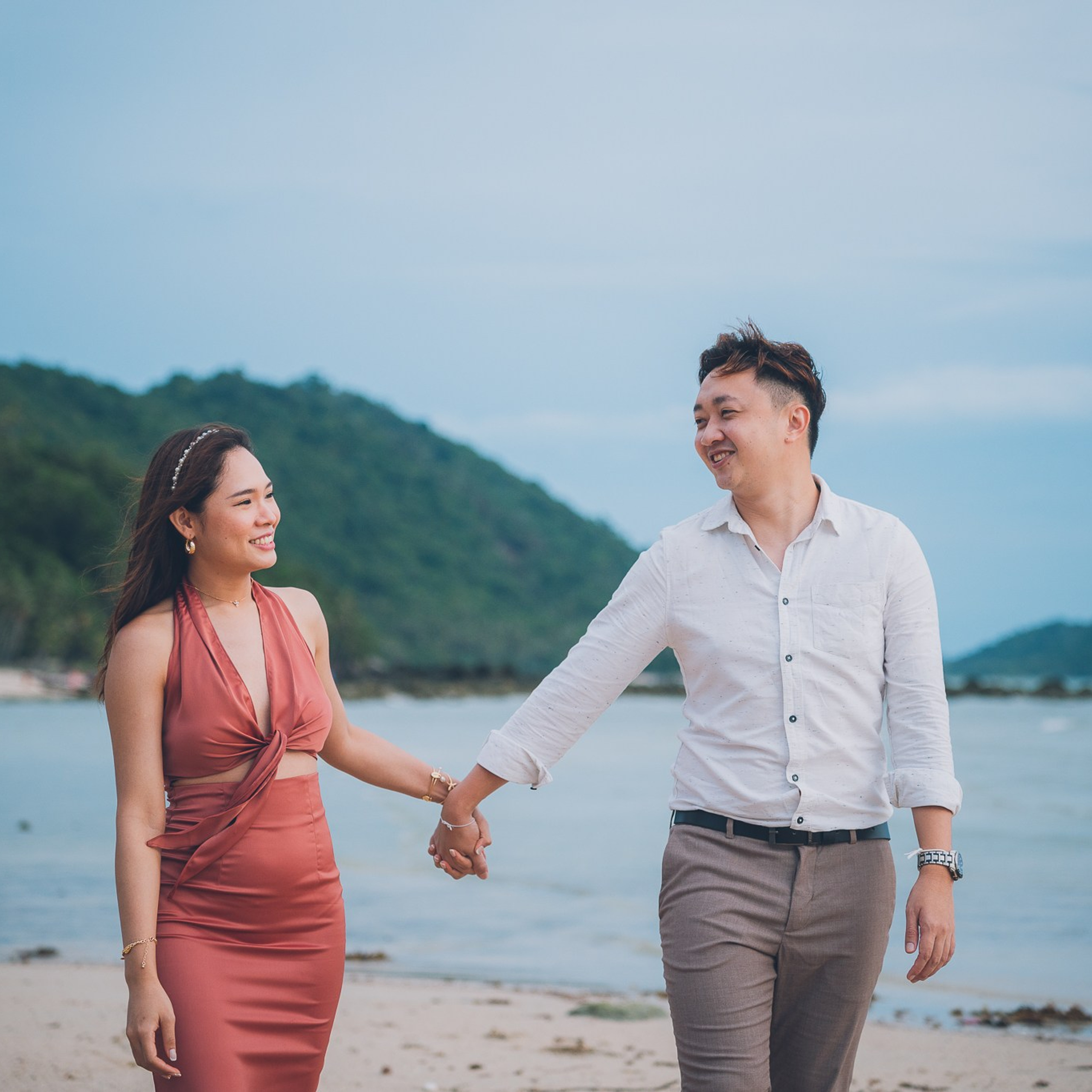 Romantic beach proposal setup in Koh Samui with candles and flower arch.