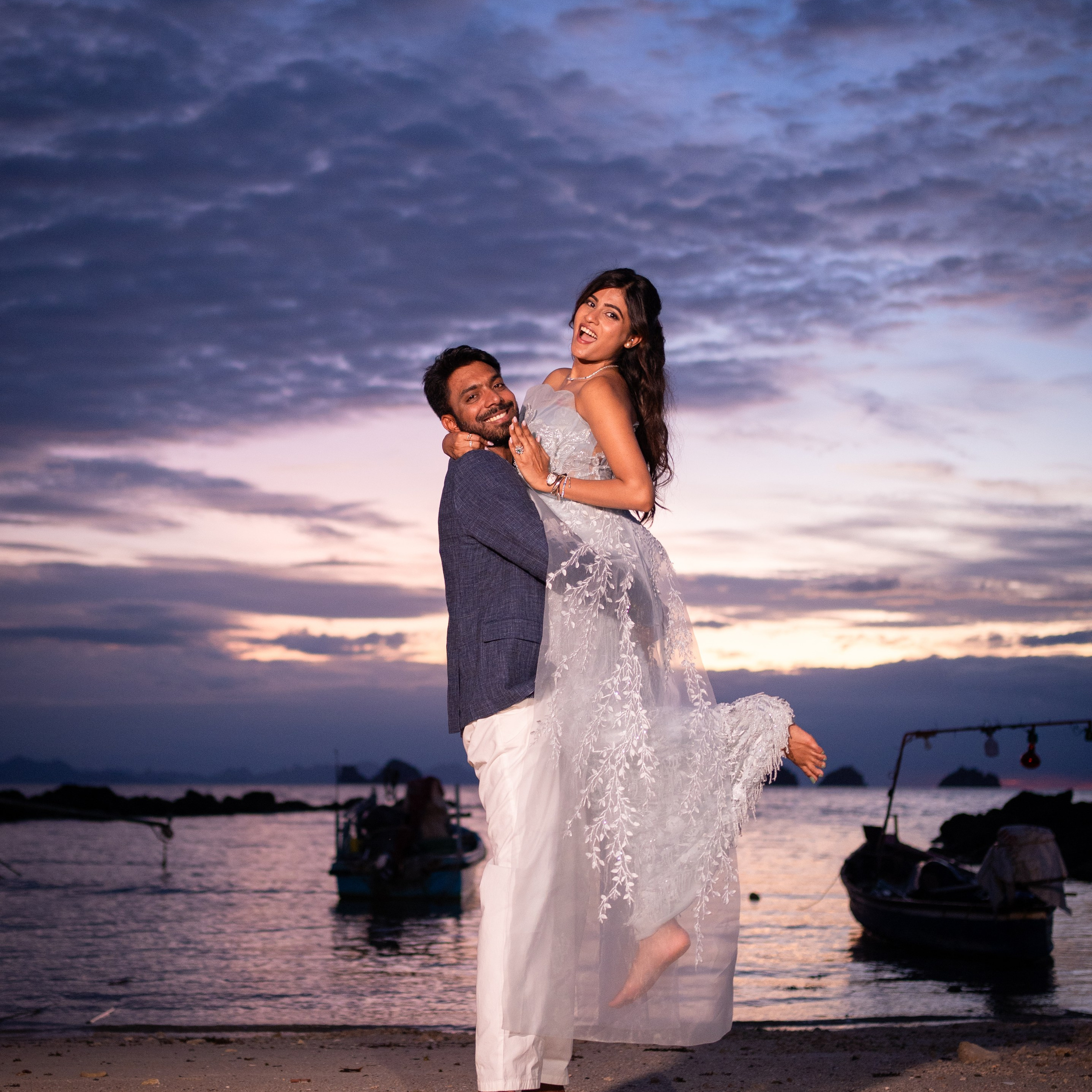 Romantic beach proposal setup in Koh Samui with candles and flower arch.
