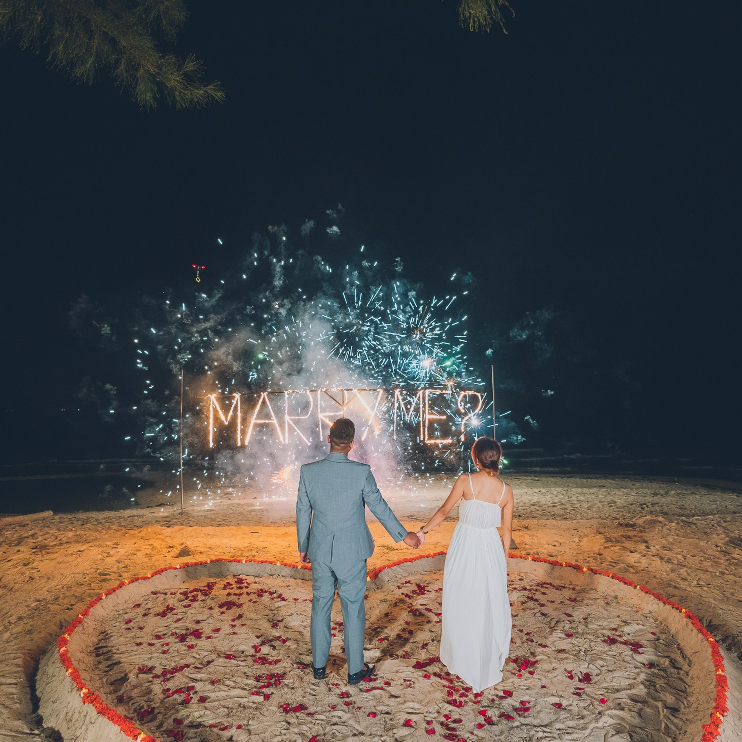 Luxury beach proposal in Koh Samui, Thailand. Private sunset setup with candles, flowers, and ocean view for an unforgettable engagement experience.