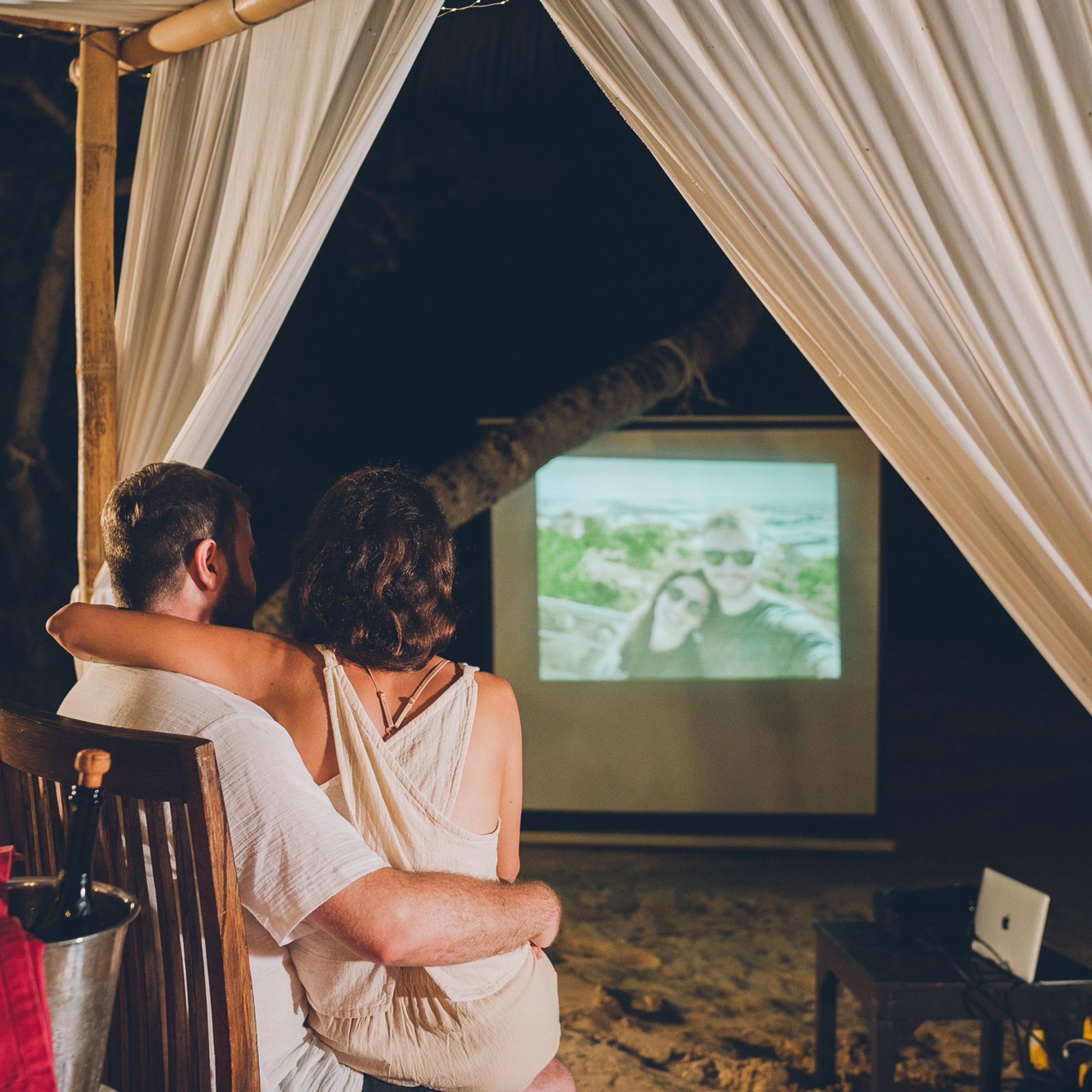 Romantic beach proposal setup in Koh Samui with candles and flower arch.