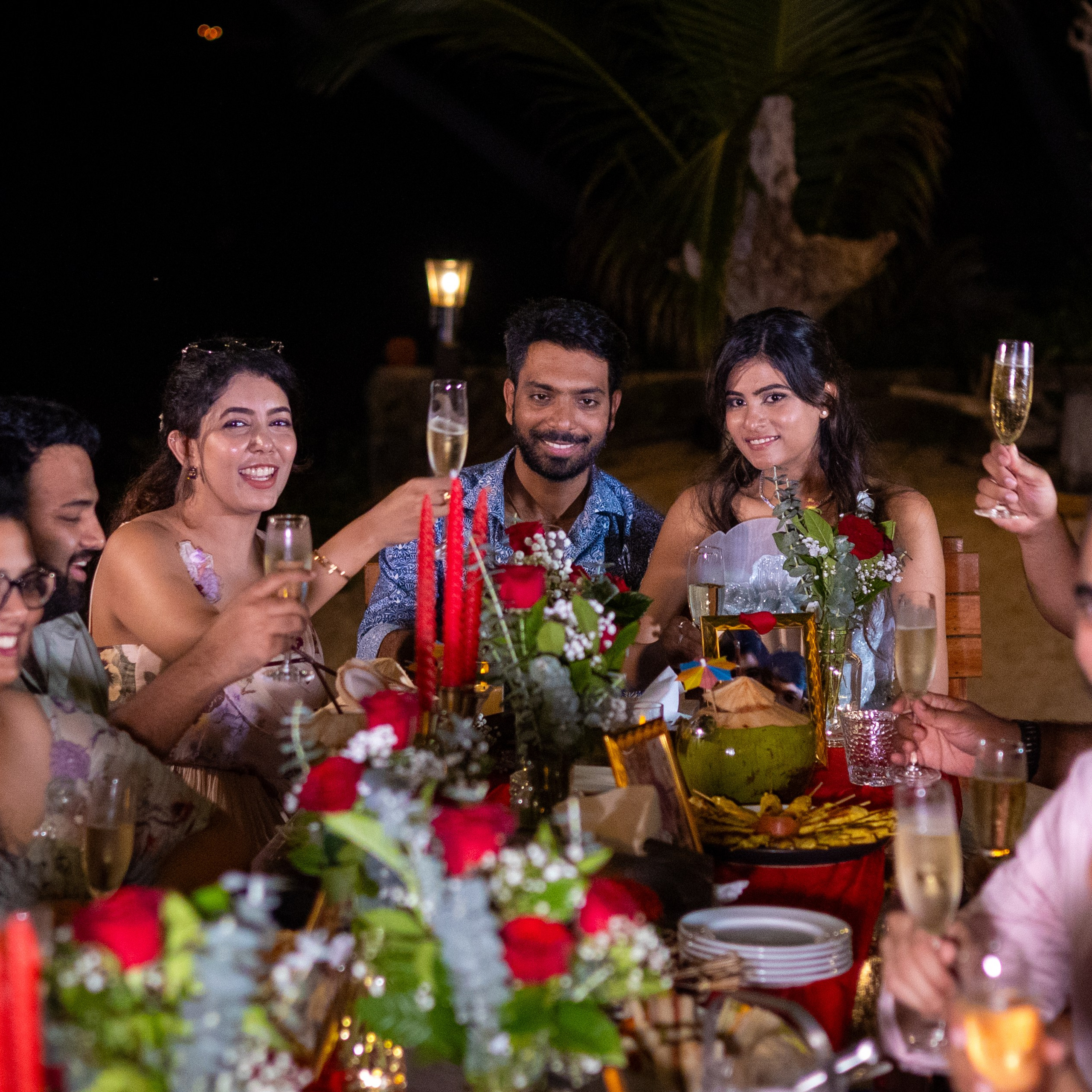 Romantic beach proposal setup in Koh Samui with candles and flower arch.