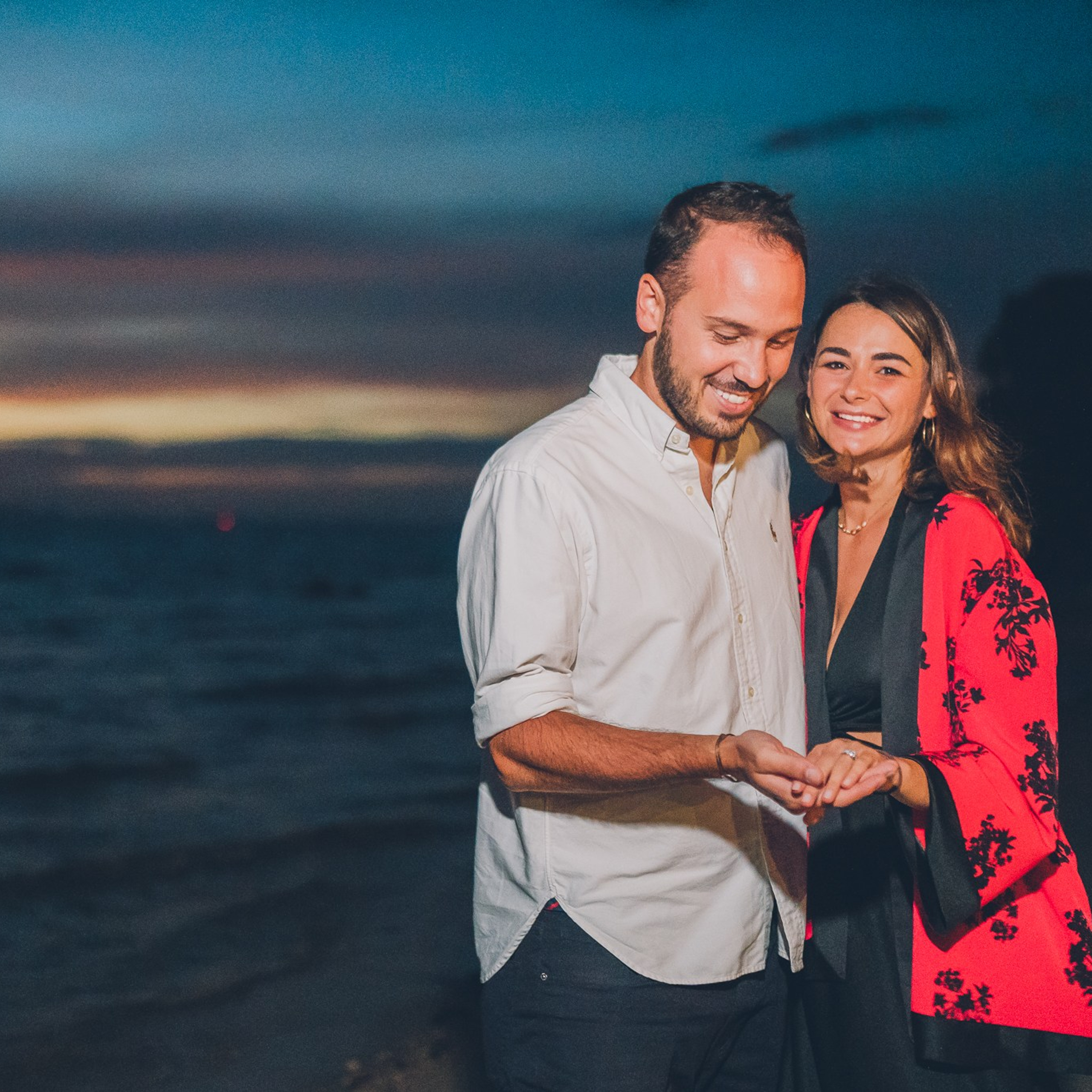 Romantic beach proposal setup in Koh Samui with candles and flower arch.