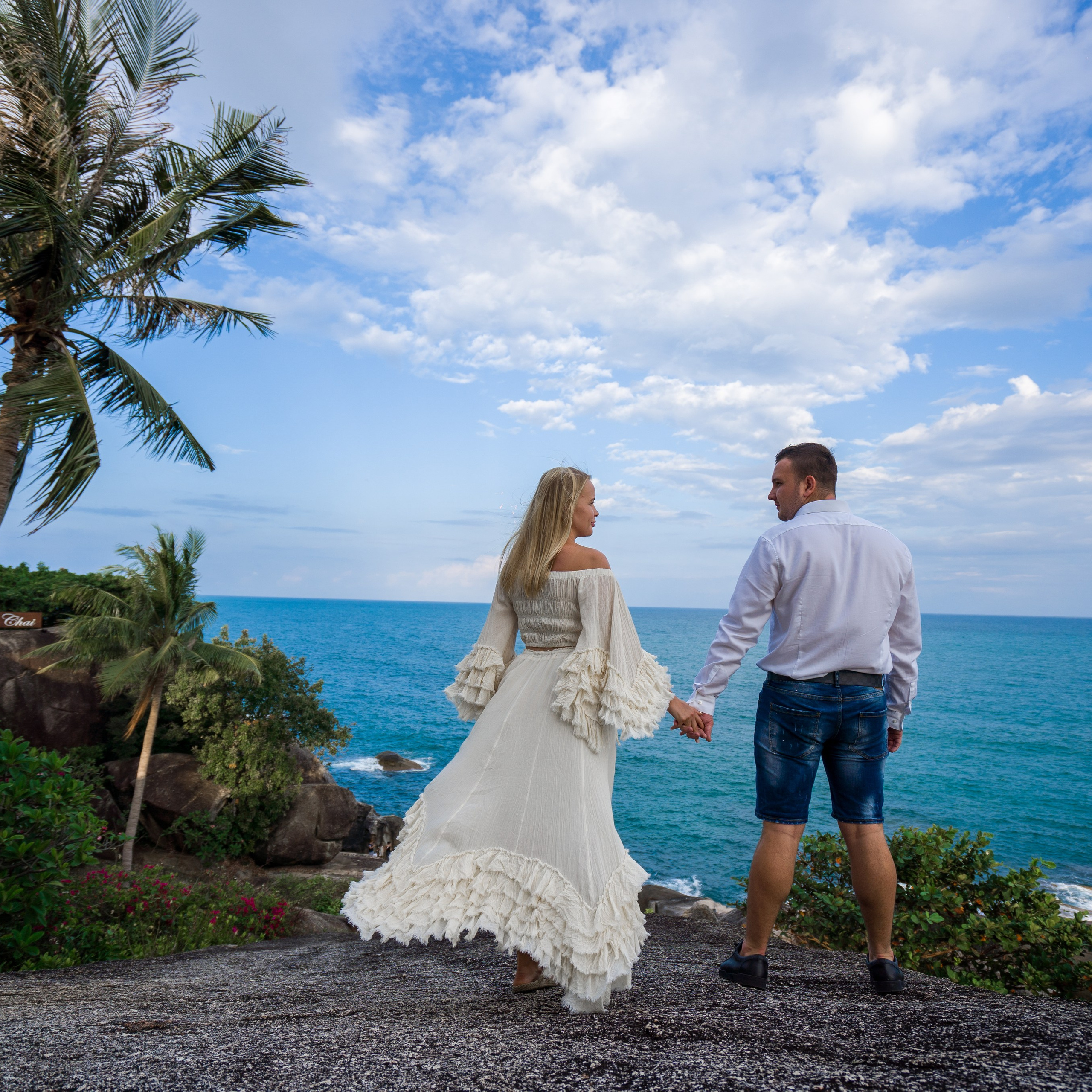 Romantic beach proposal setup in Koh Samui with candles and flower arch.