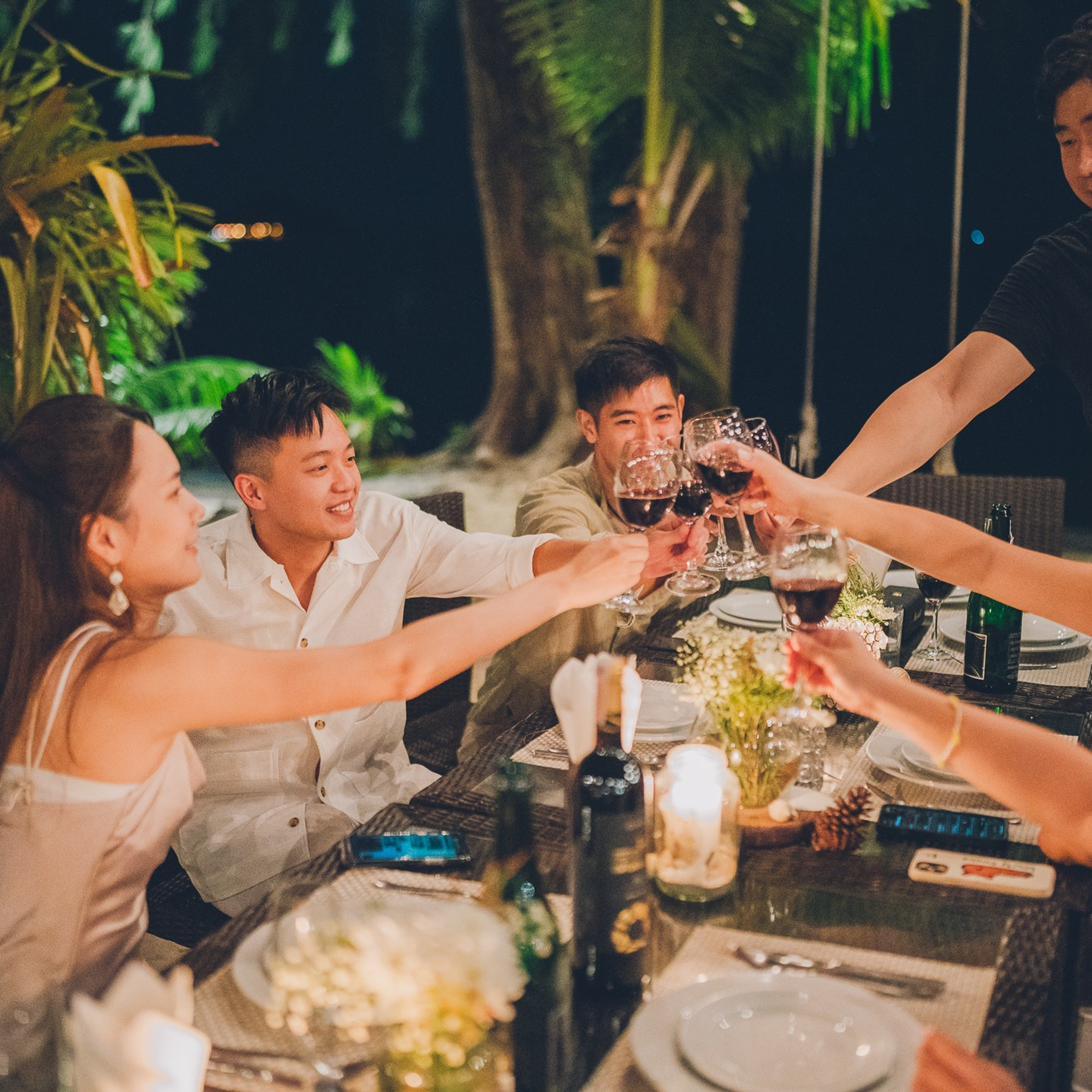 Romantic beach proposal setup in Koh Samui with candles and flower arch.