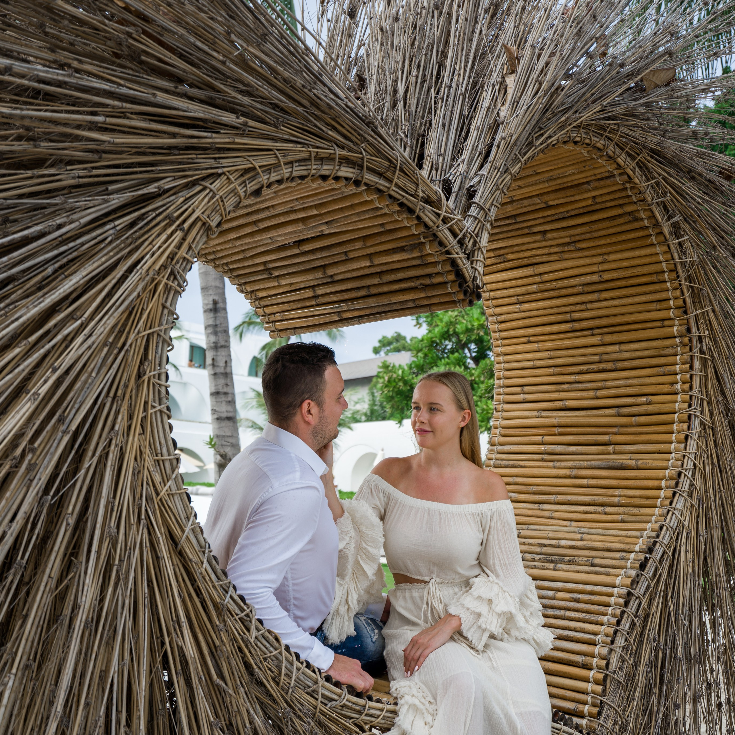 Romantic beach proposal setup in Koh Samui with candles and flower arch.