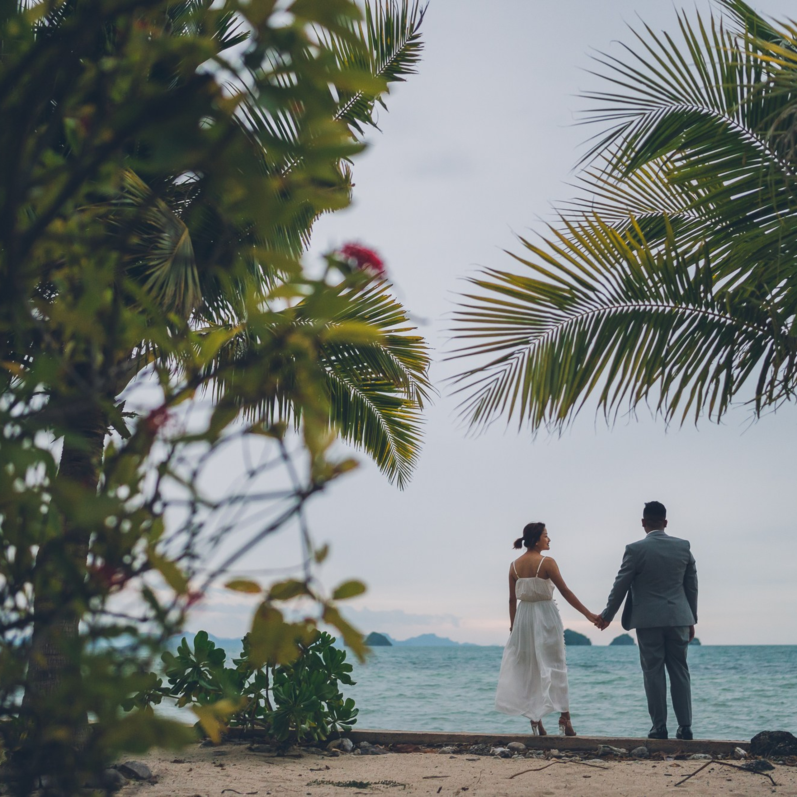 Romantic beach proposal setup in Koh Samui with candles and flower arch.