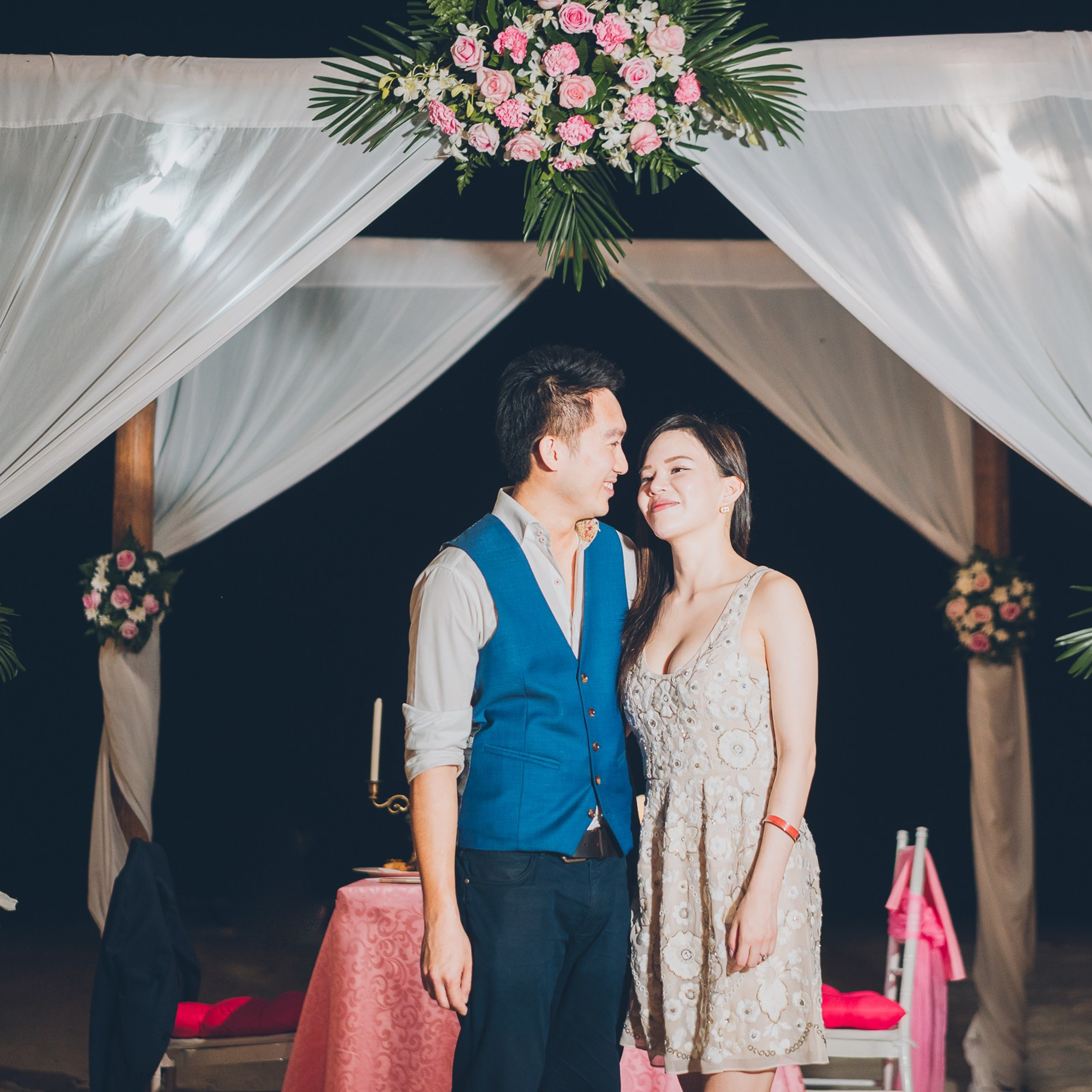 Romantic beach proposal setup in Koh Samui with candles and flower arch.
