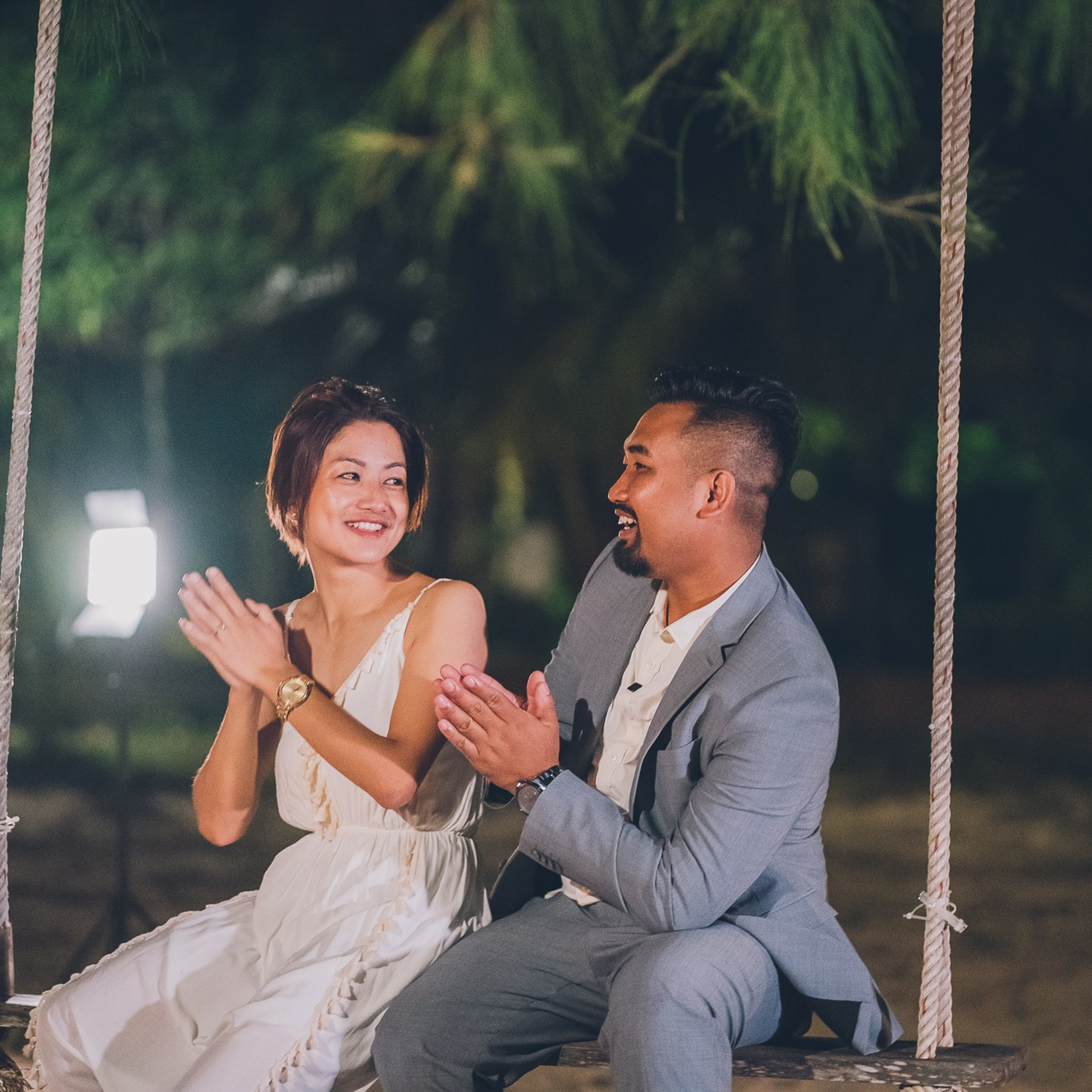 Romantic beach proposal setup in Koh Samui with candles and flower arch.