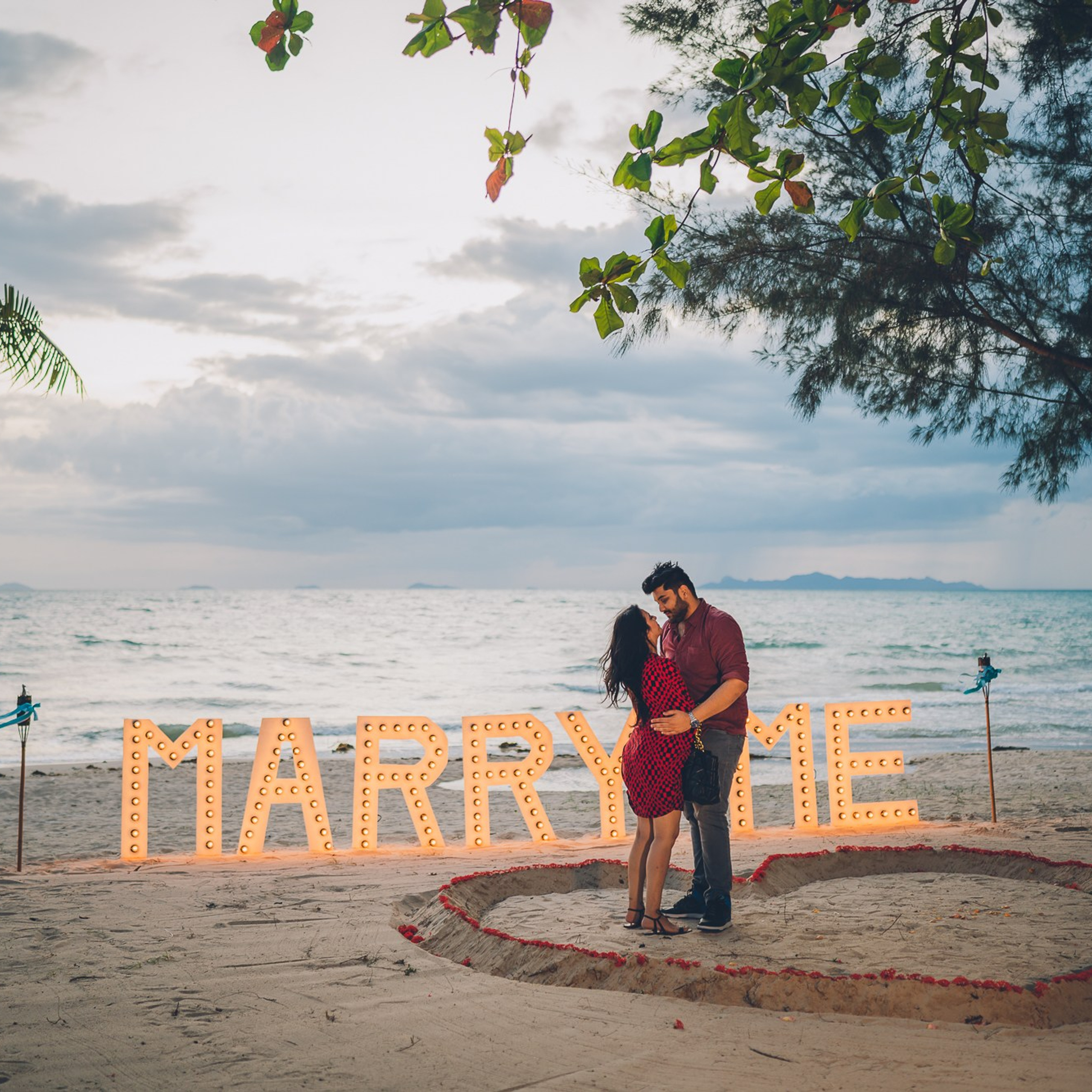 Luxury beach proposal in Koh Samui, Thailand. Private sunset setup with candles, flowers, and ocean view for an unforgettable engagement experience.