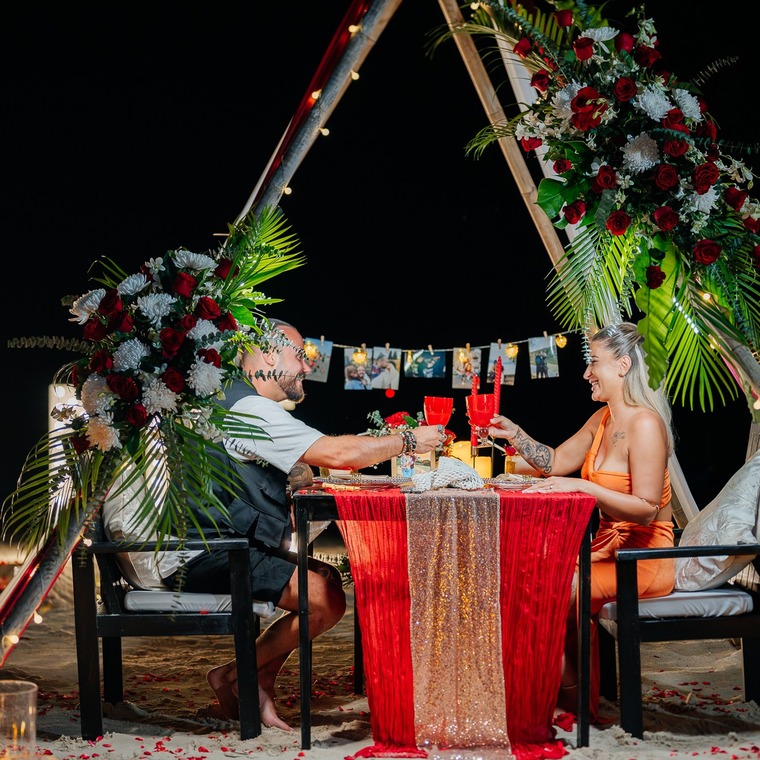 Romantic beach proposal setup in Koh Samui with candles and flower arch.