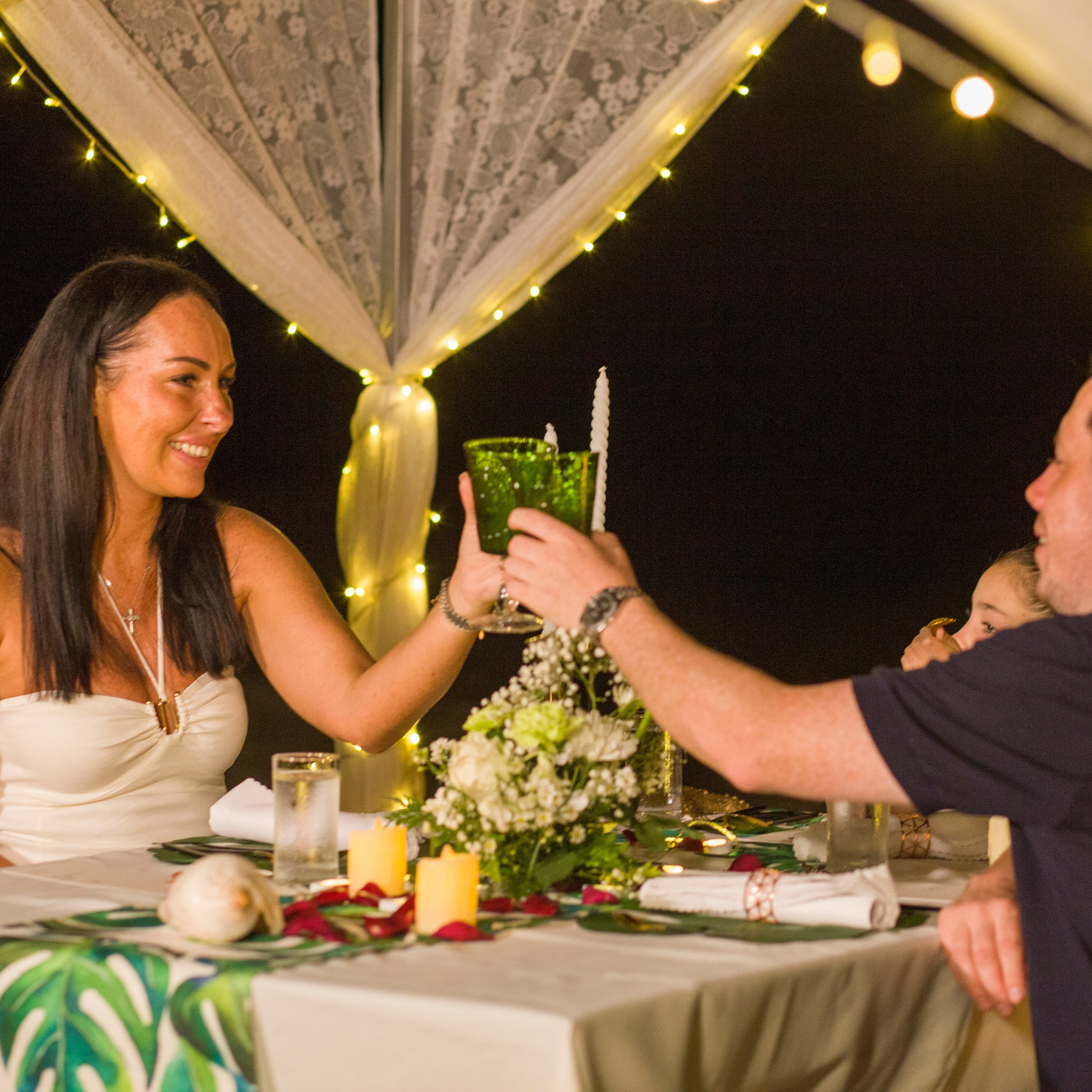 Romantic beach proposal setup in Koh Samui with candles and flower arch.