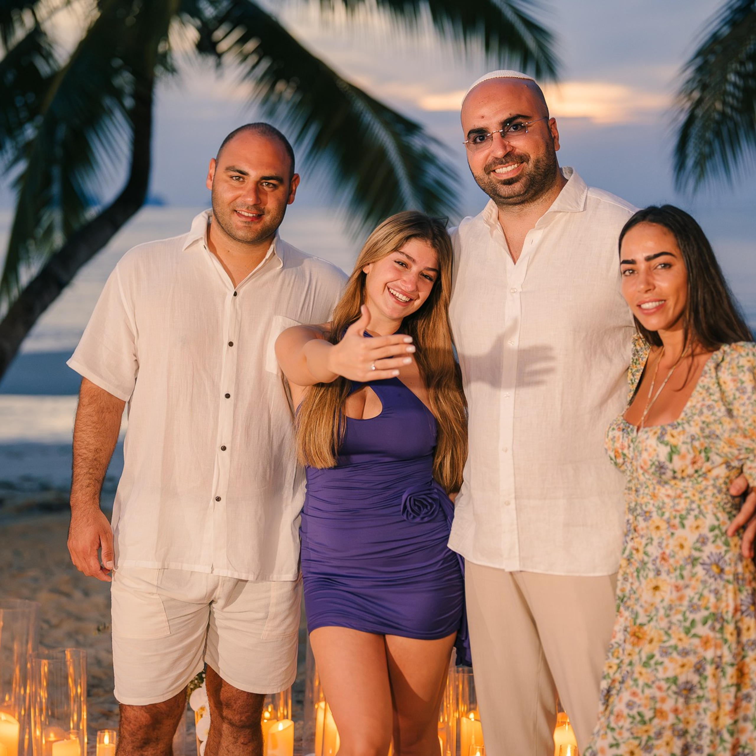 Romantic beach proposal setup in Koh Samui with candles and flower arch.