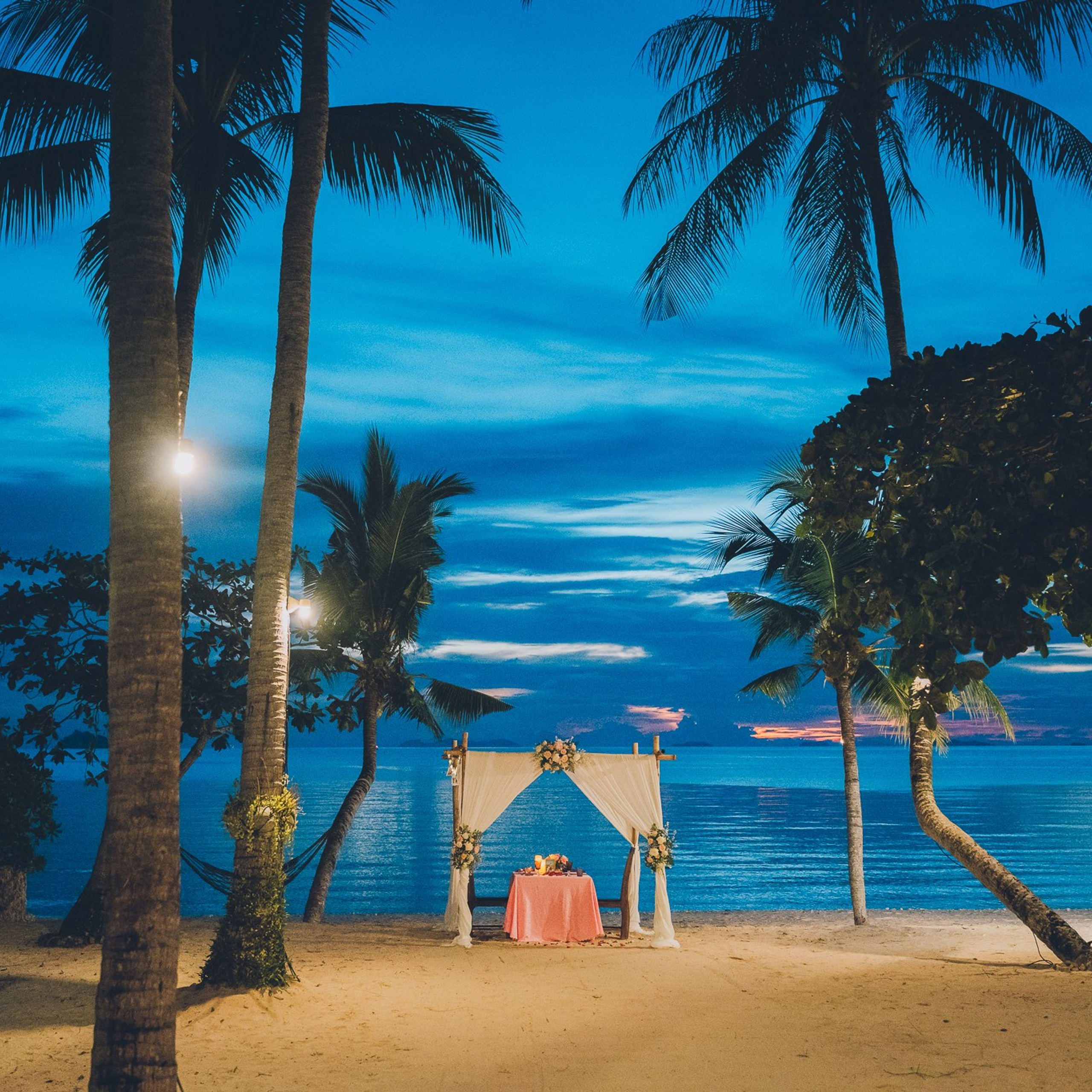 Luxury beach proposal in Koh Samui, Thailand. Private sunset setup with candles, flowers, and ocean view for an unforgettable engagement experience.