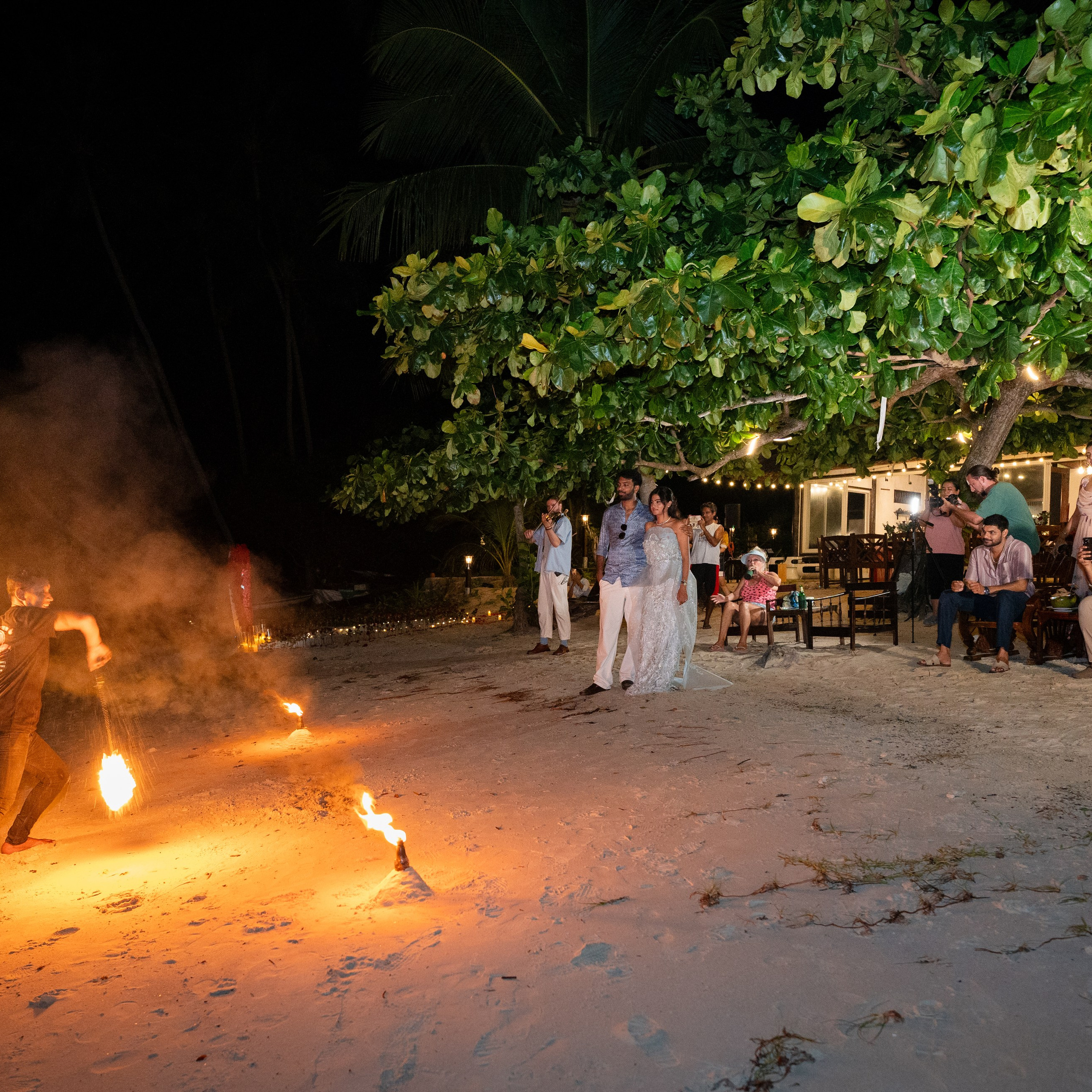 Romantic beach proposal setup in Koh Samui with candles and flower arch.