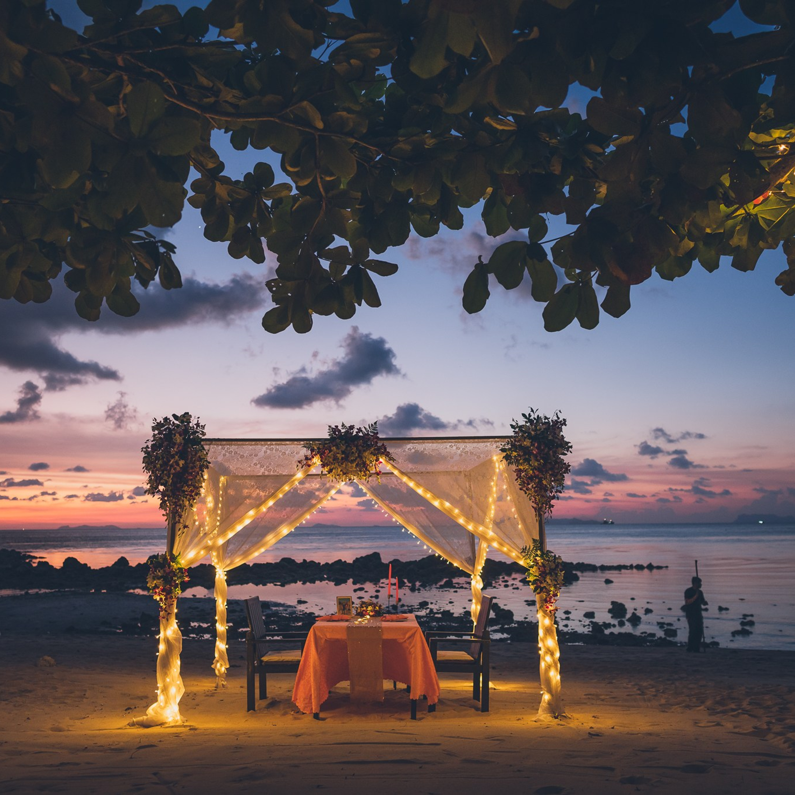 Luxury beach proposal in Koh Samui, Thailand. Private sunset setup with candles, flowers, and ocean view for an unforgettable engagement experience.