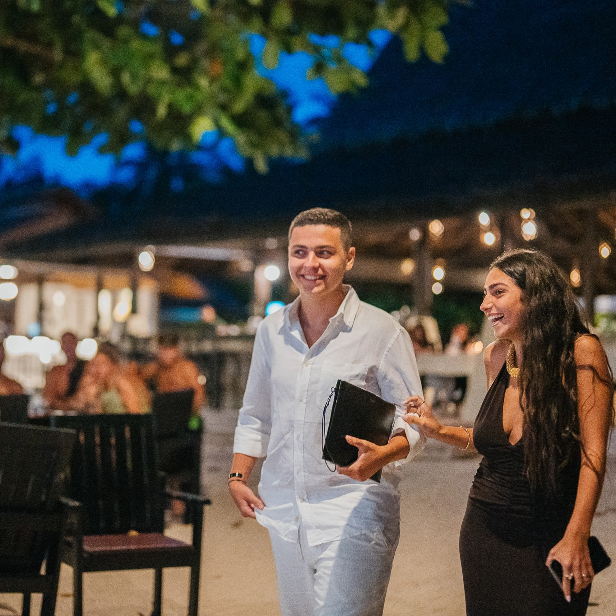 Romantic beach proposal setup in Koh Samui with candles and flower arch.