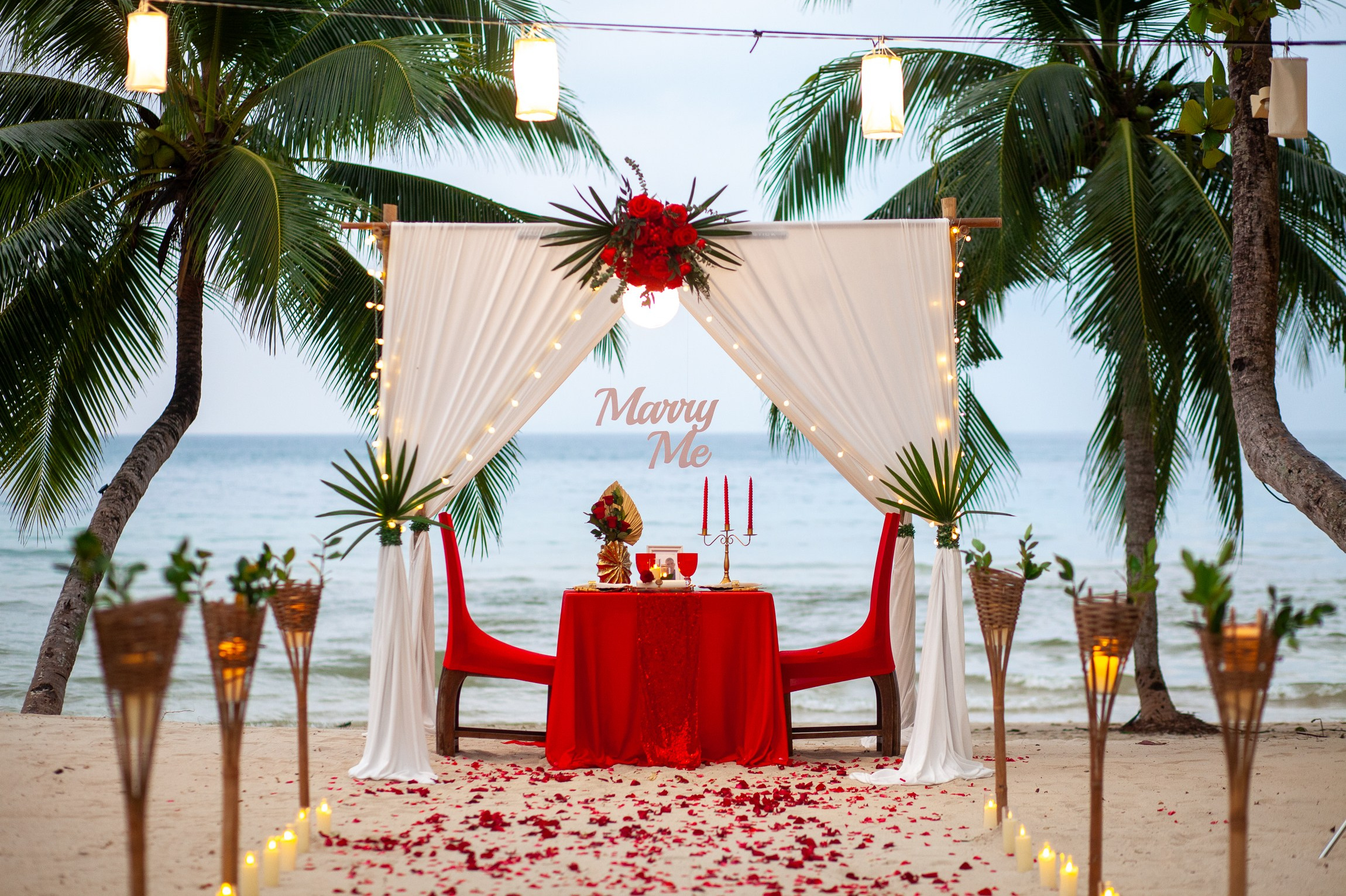 Romantic dinner and proposal setup on Koh Samui beach for couples celebrating engagement.