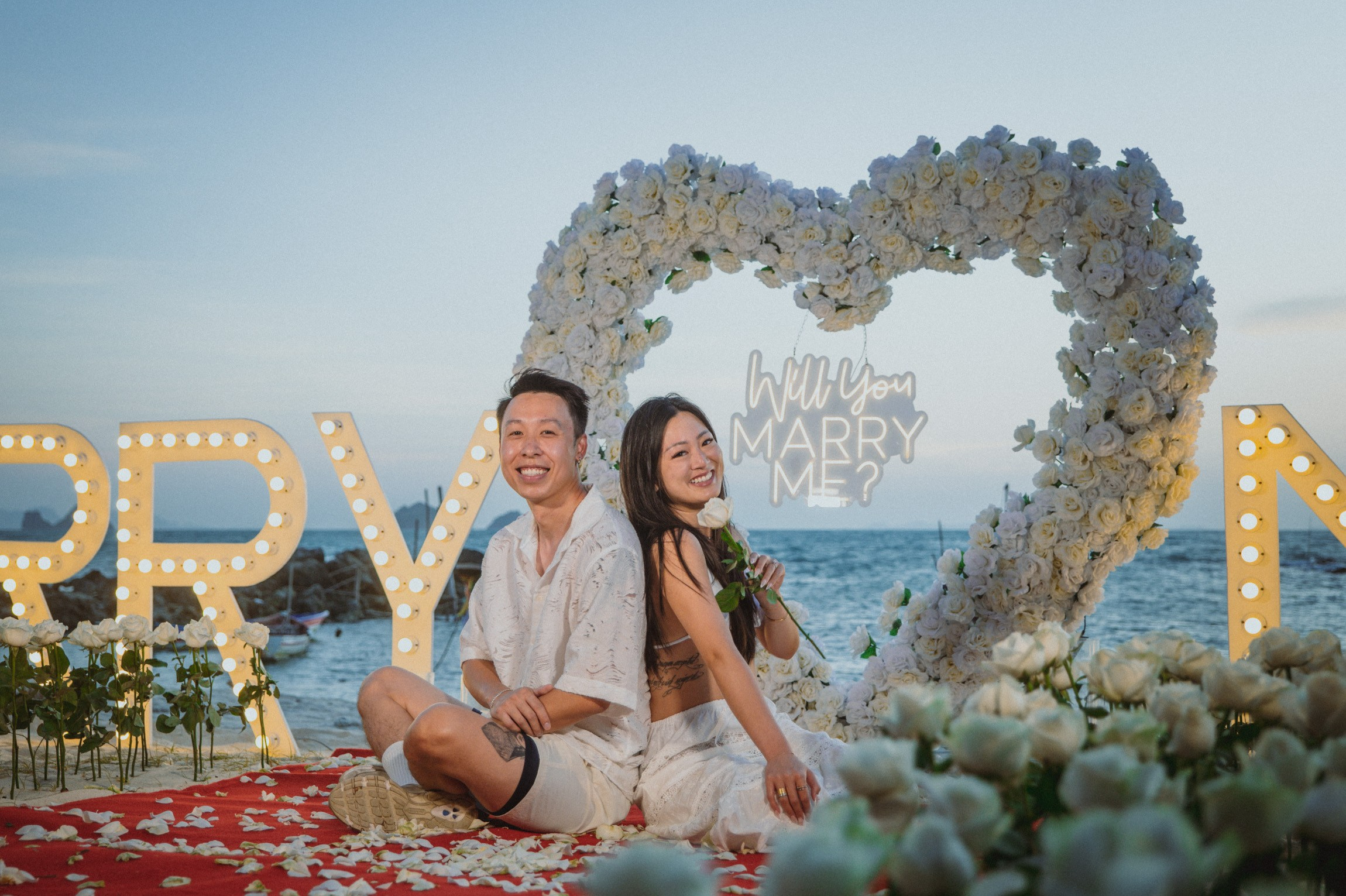 Luxury marriage proposal on a private beach in Koh Samui with flower decorations and romantic lighting.