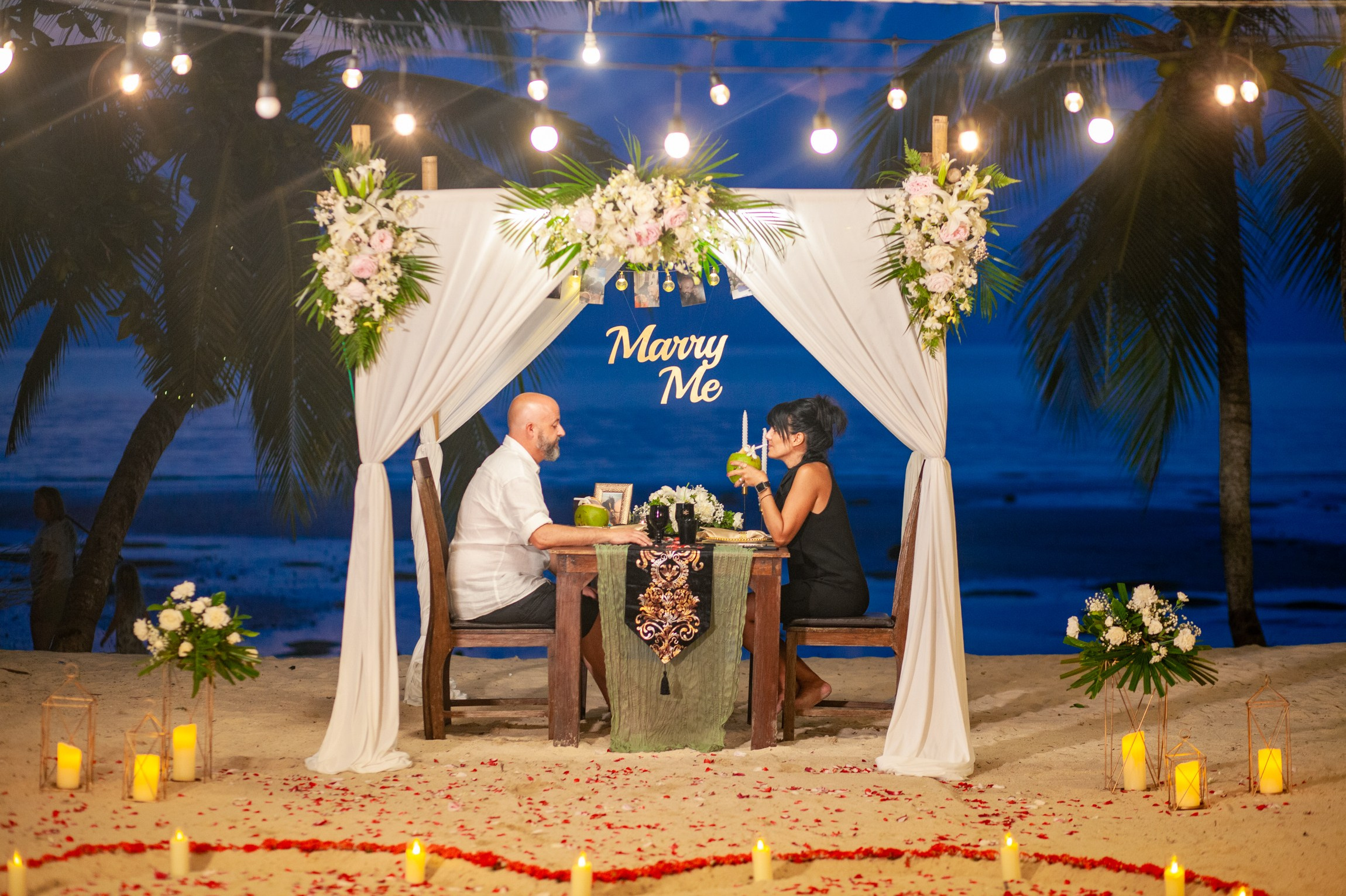 Romantic dinner and proposal setup on Koh Samui beach for couples celebrating engagement.