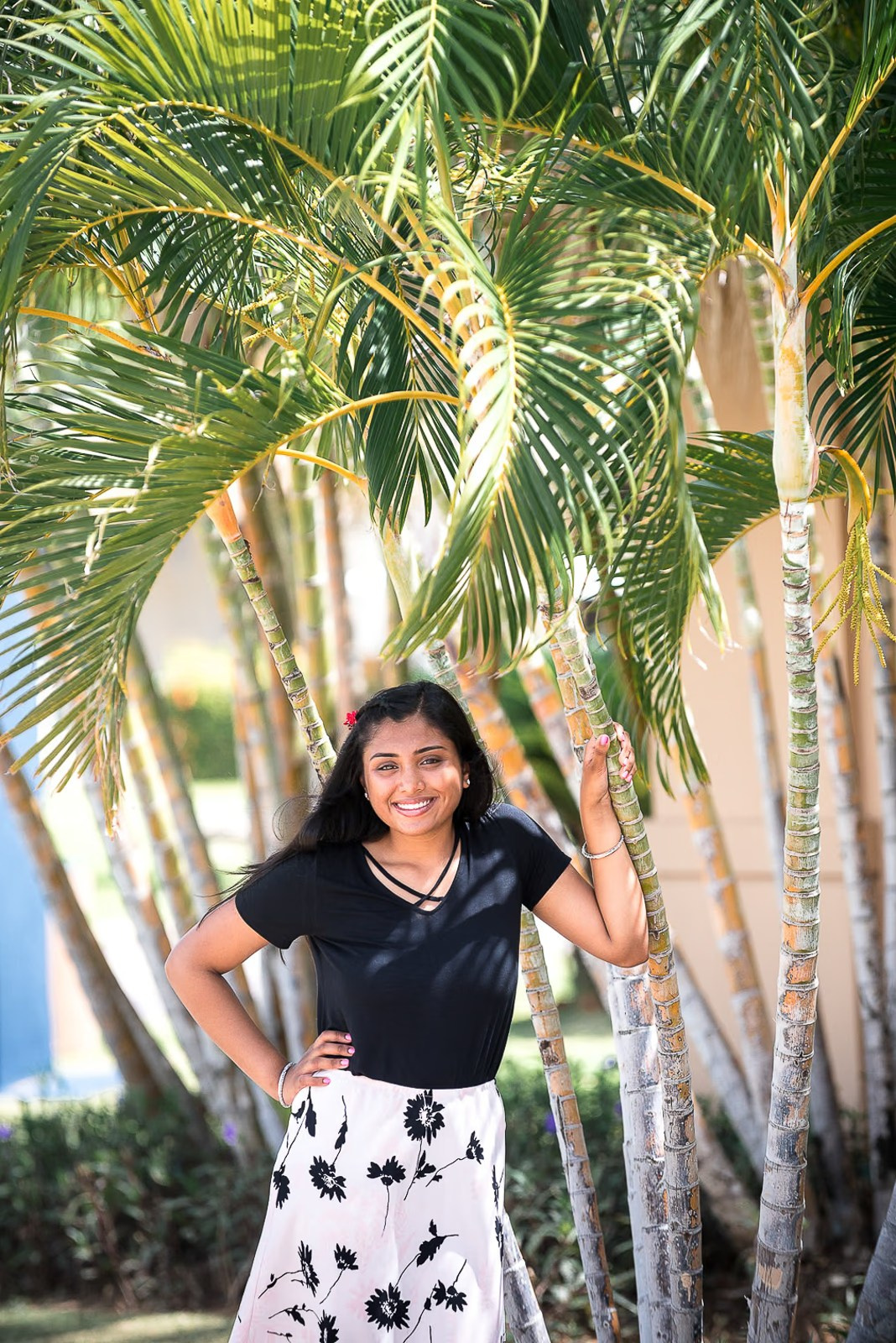 Portrait of a woman posing with palm trees in the background during a photoshoot in the Dominican Republic