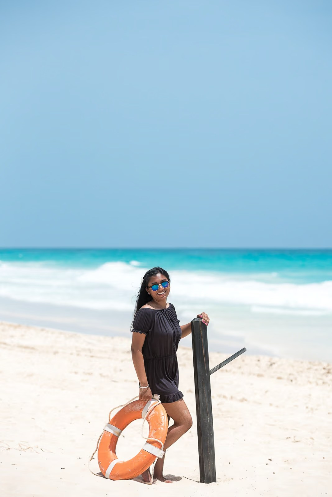 Indian woman posing with a life ring on Bavaro Beach in Punta Cana