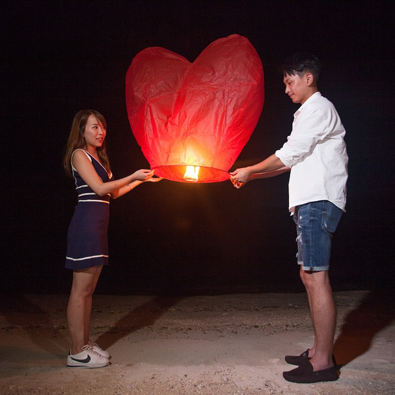 Romantic beach proposal setup in Koh Samui with candles and flower arch.
