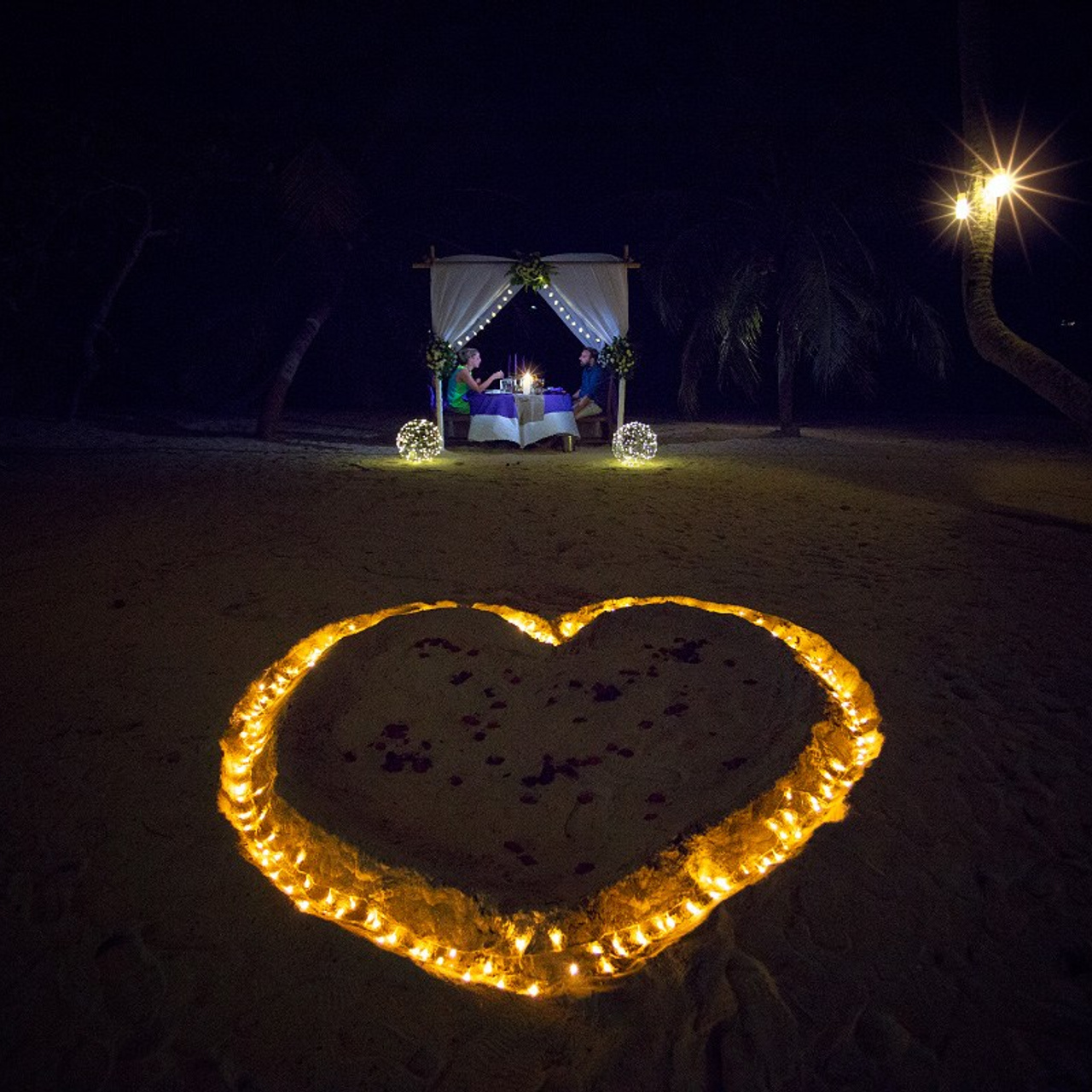 Luxury beach proposal in Koh Samui, Thailand. Private sunset setup with candles, flowers, and ocean view for an unforgettable engagement experience.