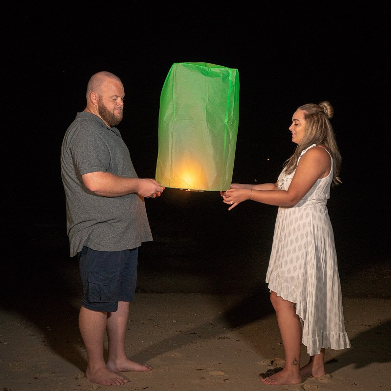 Romantic beach proposal setup in Koh Samui with candles and flower arch.
