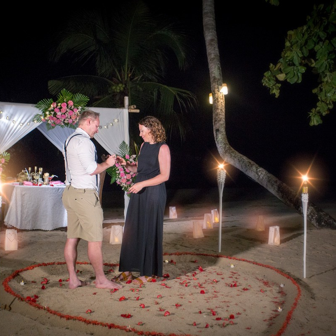 Luxury beach proposal in Koh Samui, Thailand. Private sunset setup with candles, flowers, and ocean view for an unforgettable engagement experience.